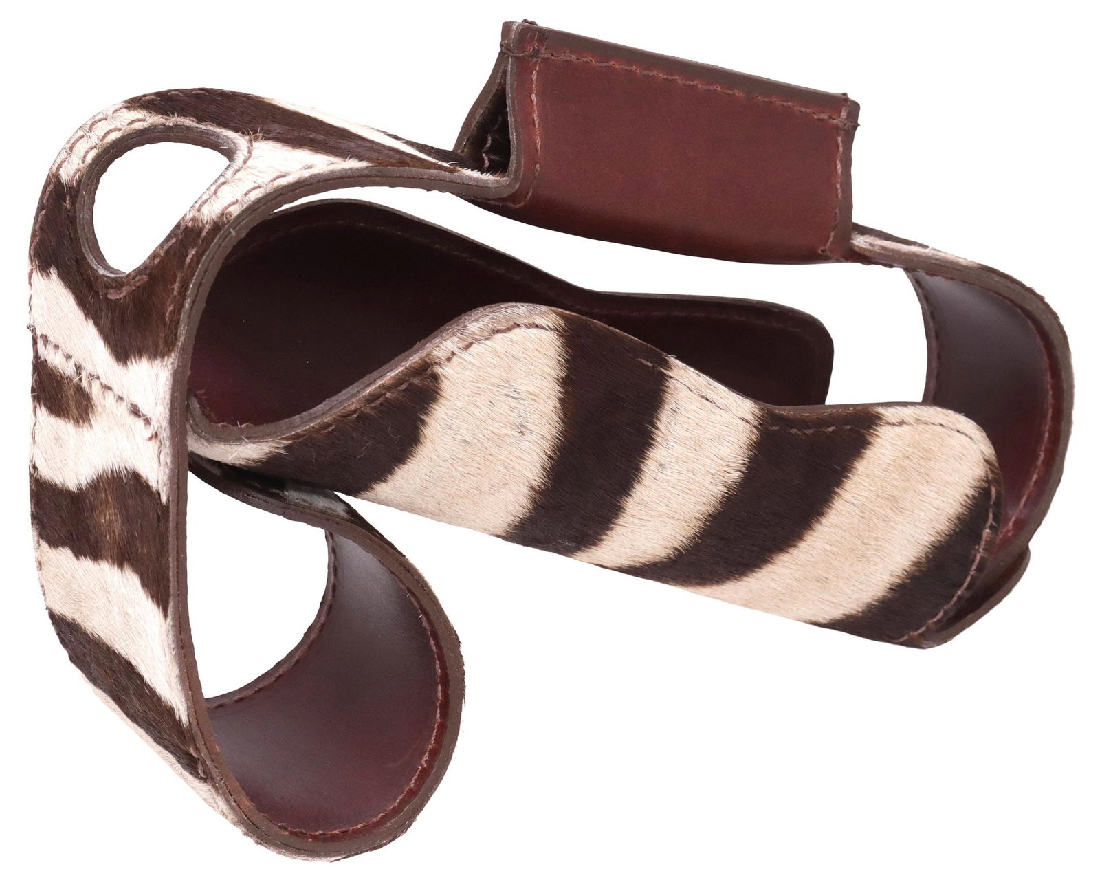TANDY ZEBRA HIDE & LEATHER WINE / CHAMPAGNE BOTTLE HOLDER: Zebra hide wine/ champagne bottle holder, Tandy Leather, 21st c., with stitched brown leather lining, branded button fasteners, approx 6"h, 9.5"w, 3.25"d, <1lb **Provenance:
