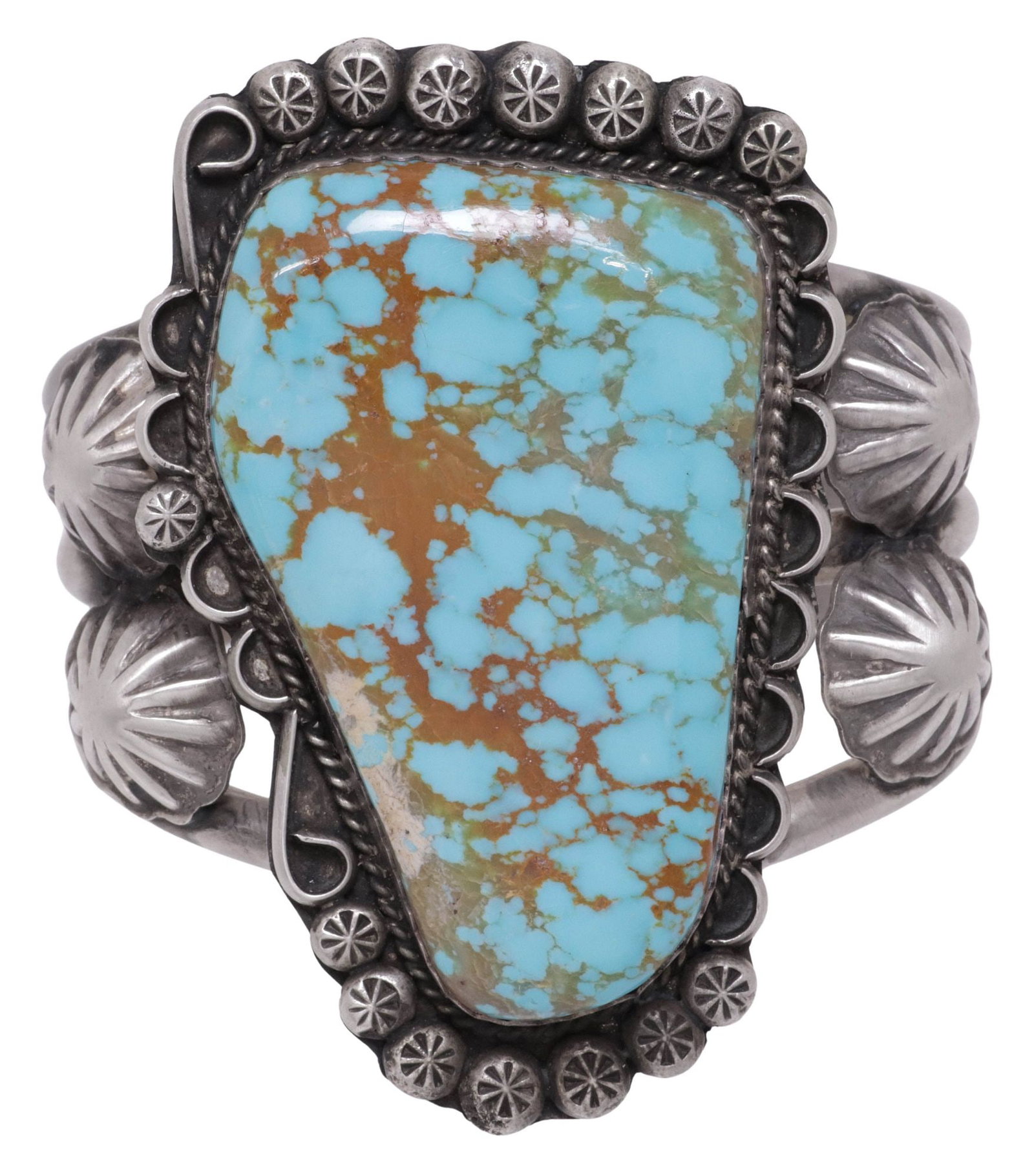 LARGE NATIVE AMERICAN STERLING SILVER & TURQUOISE CUFF BRACELET: Native American sterling silver and turquoise cuff bracelet, large bezel-set freeform turquoise cabochon, framed by rope trim and stamped floral motifs, scalloped border, on a split shank cuff, marked