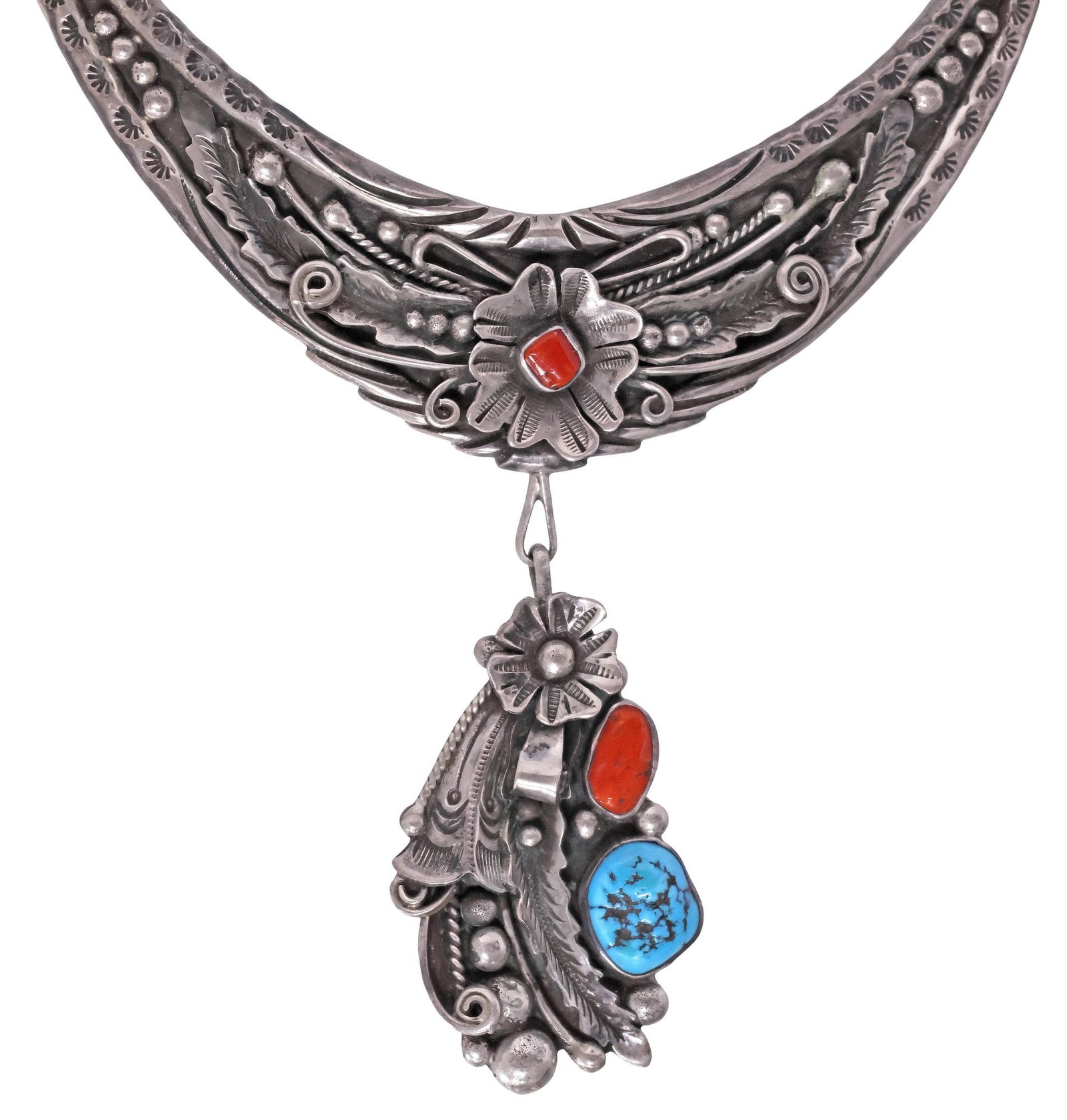 NATIVE AMERICAN SILVER, TURQUOISE & RED CORAL PENDANT NECKLACE: Native American silver (content unknown) and gemstone pendant necklace, having crescent-shaped station with feathers, scrolls, and stampwork motifs, issuing floral drop pendant, set with red coral and