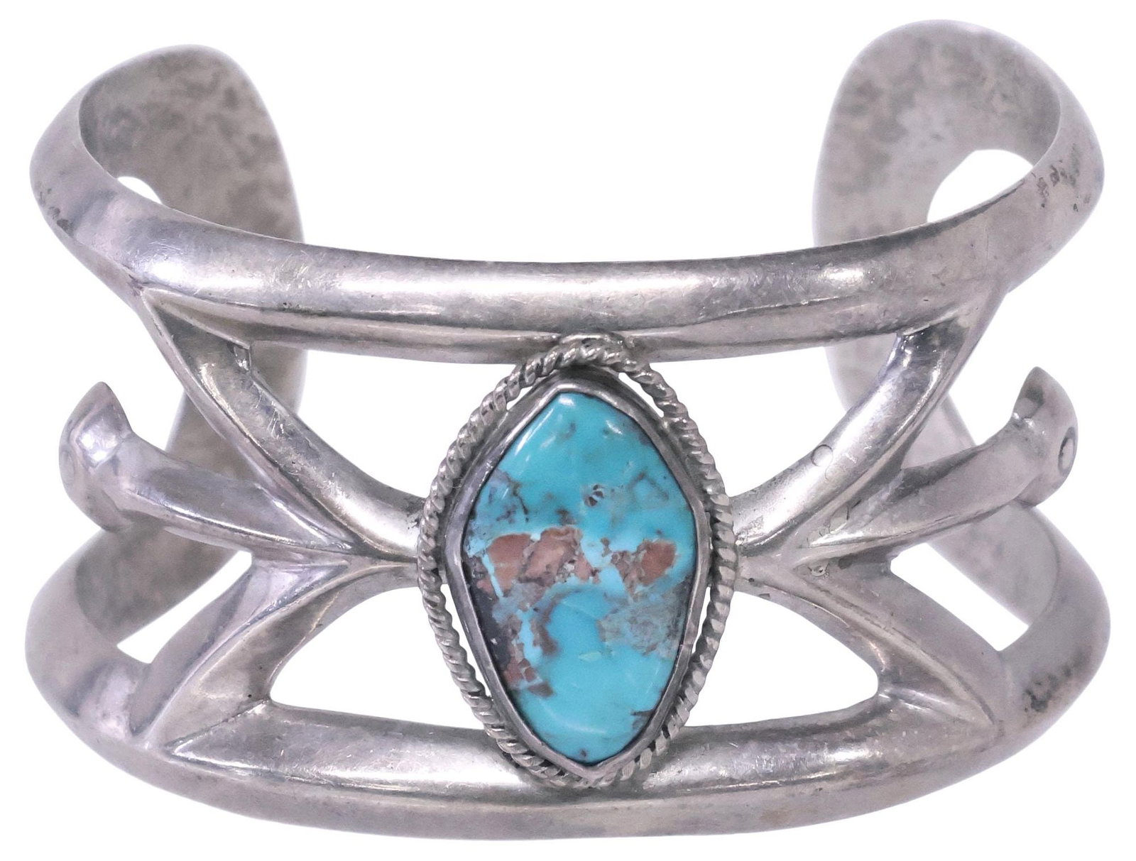 NATIVE AMERICAN TUFA CAST SILVER & TURQUOISE OPENWORK CUFF BRACELET: Native American tufa cast silver (content unknown) cuff bracelet, openwork band centering bezel-set turquoise cabochon, in twisted rope surround, signed DTB, approx 1.5"w, interior: approx 5.25"l, gap