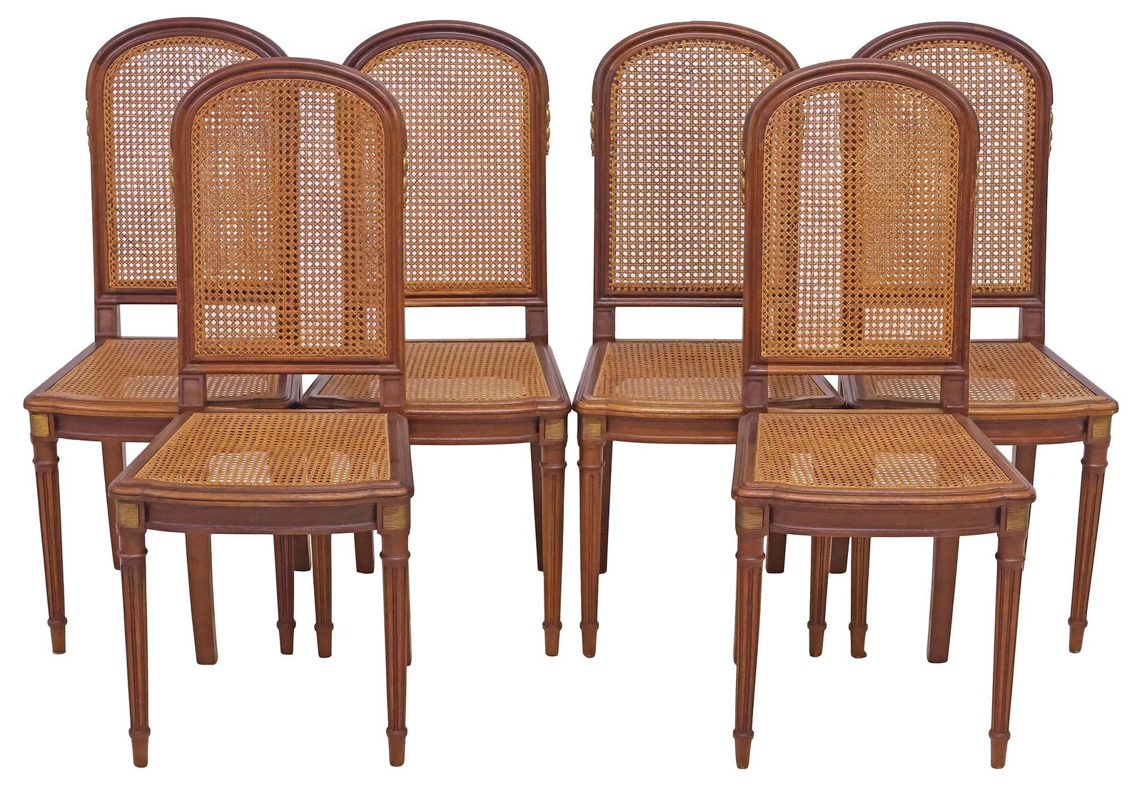 (6) FRENCH LOUIS XVI STYLE CANED WALNUT DINING CHAIRS: (lot of 6) French Louis XVI style walnut side chairs, early 20th c., each having caned back and seat, with gilt-metal mounts, rising on tapering fluted legs, ending on arrow feet, (three) with small l