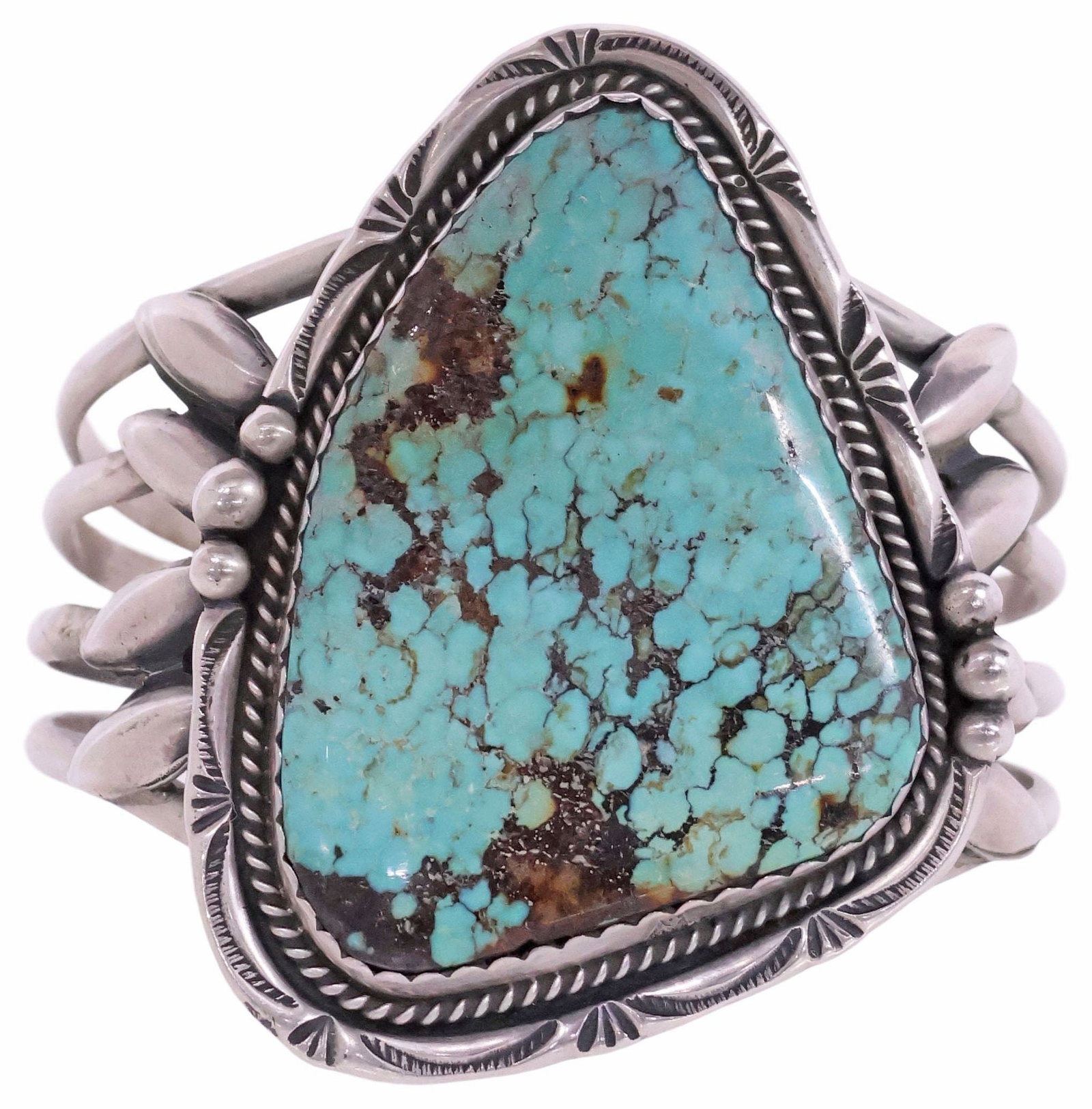 NATIVE AMERICAN SILVER & TURQUOISE CABOCHON CUFF BRACELET: Native American silver (content unknown) and turquoise cuff bracelet, likely Navajo, large bezel-set turquoise cabochon with roped trim and stampwork motifs, on a split shank cuff, unmarked, approx 2.
