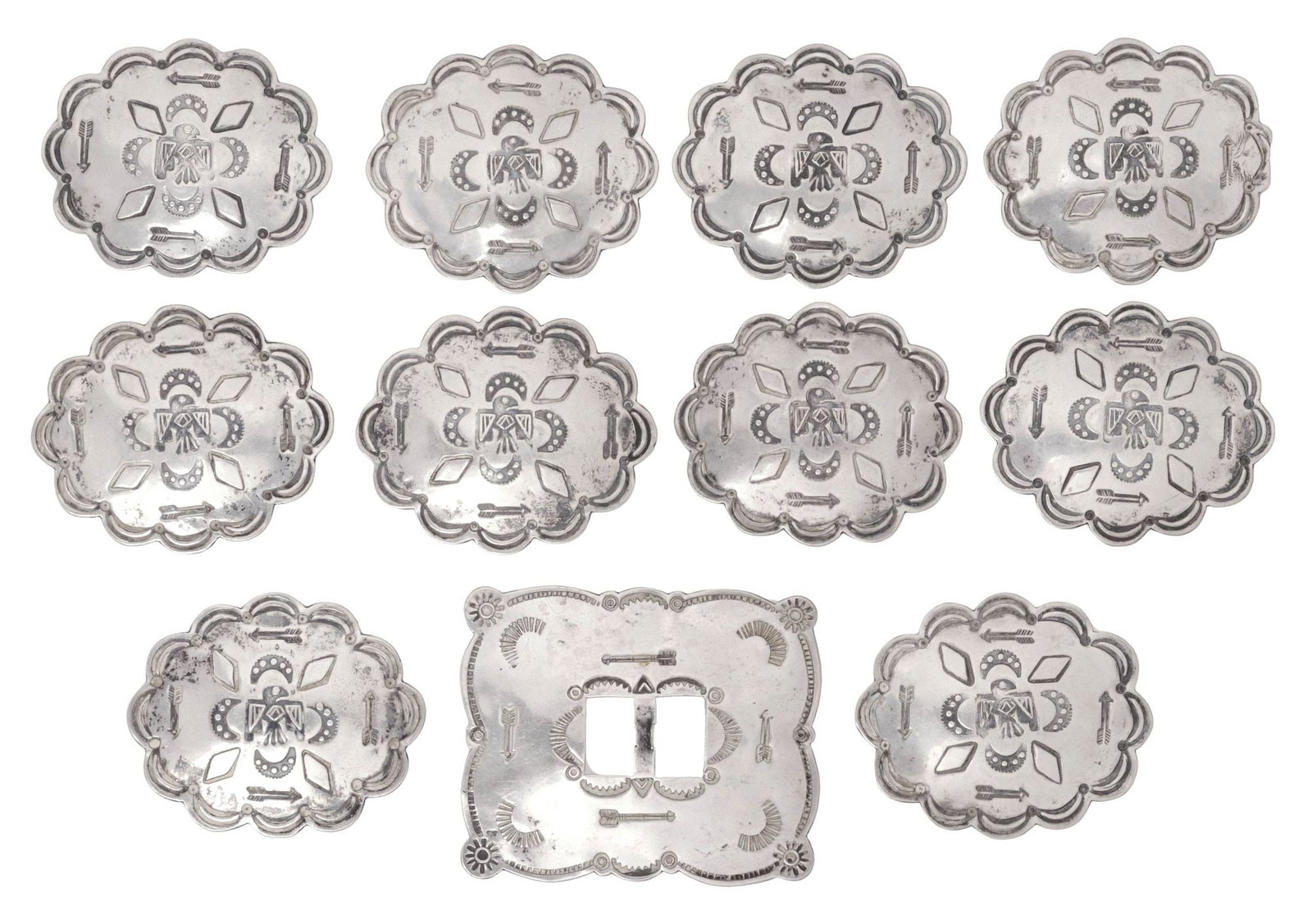 (11) NATIVE AMERICAN STAMPWORK SILVER CONCHOS: (lot of 11) Native American silver (content unknown) conchos, likely Navajo/ Dine, each with stamped geometric and celestial motifs, unmarked, including: (1) scalloped-edge medallions with central thu
