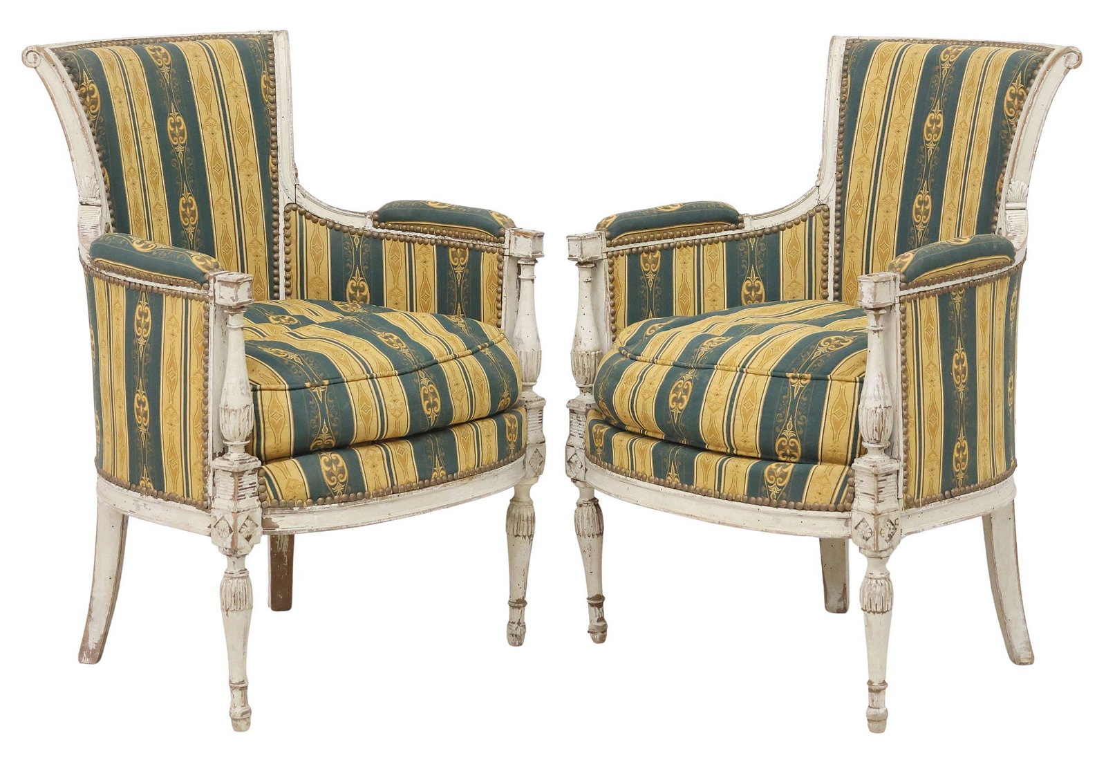 (2) FRENCH LOUIS XVI STYLE PAINT-DECORATED BERGERES / ARMCHAIRS: (pair) Continental Louis XVI style paint-decorated bergeres/ armchairs, early 20th c., each in later striped upholstery, with nail head trim, removable seat cushion, rising on turned and fluted legs, 