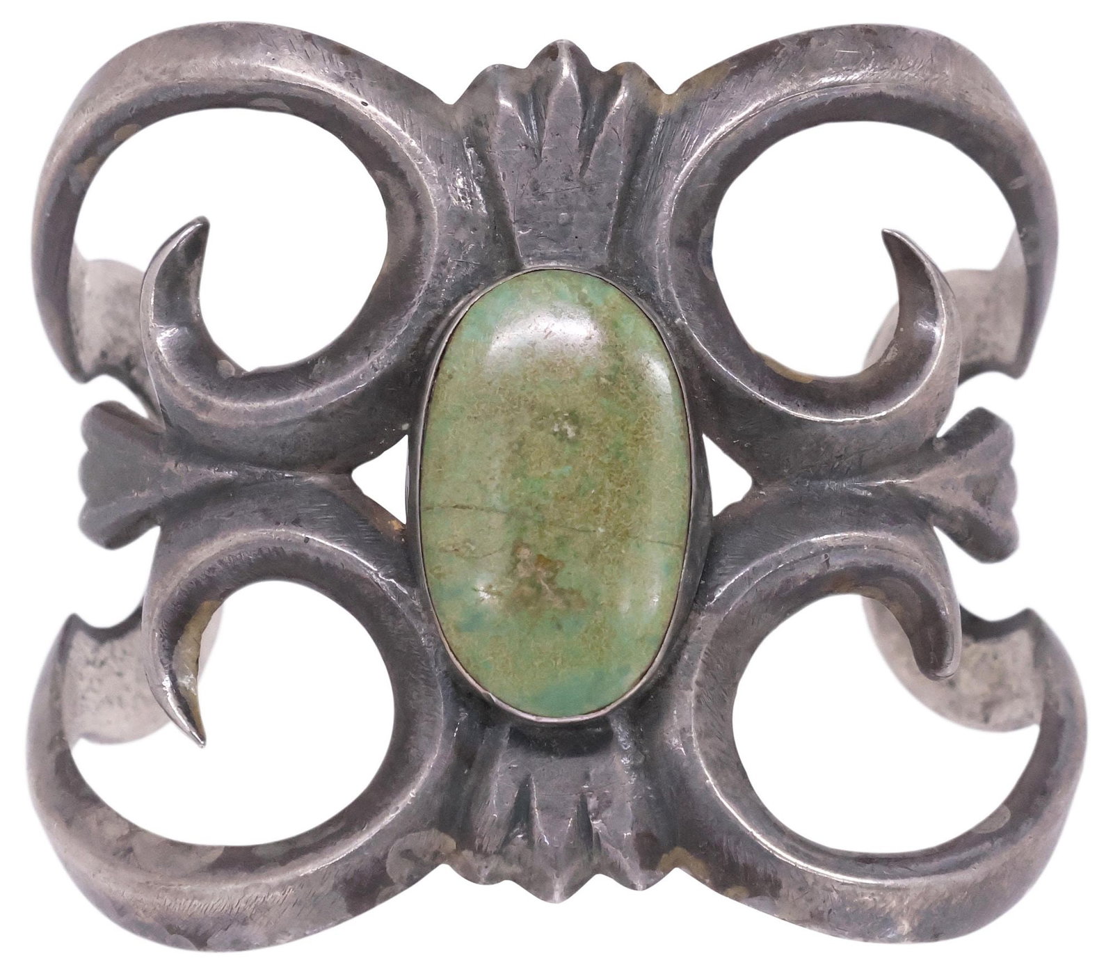 NATIVE AMERICAN TUFA CAST SILVER & TURQUOISE OPENWORK CUFF BRACELET: Native American tufa cast silver (content unknown) cuff bracelet, scrolling openwork band centering bezel-set oval turquoise cabochon, unmarked, stable fracture to stone, approx 2.5"w, interior: appro