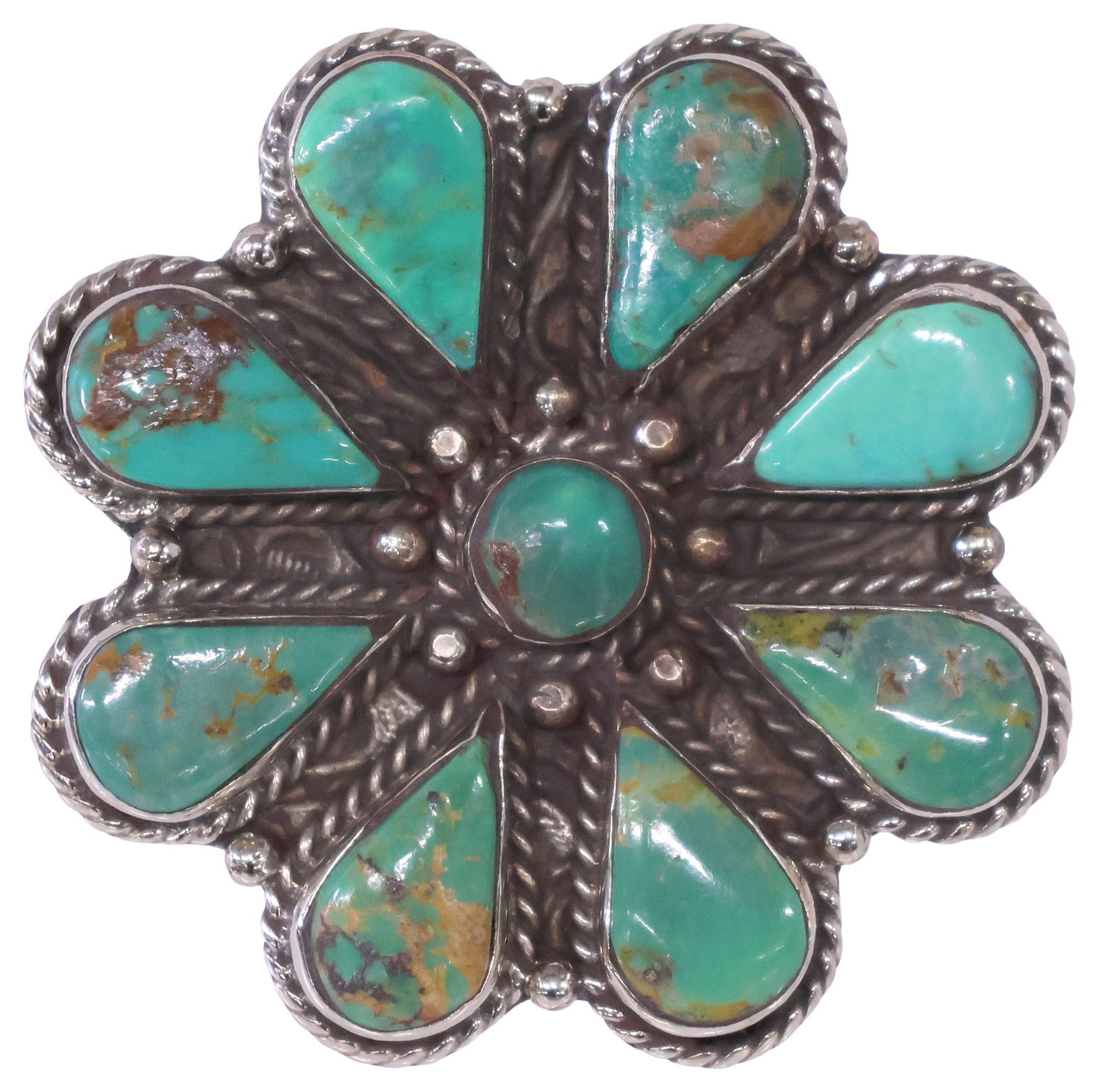 LARGE NATIVE AMERICAN SILVER & TURQUOISE FLOWER STATEMENT RING: Large Native American silver (content unknown) adjustable flower ring, large floriform plaque set with (nine) round and teardrop-shaped turquoise cabochons, in twisted rope surround, the reverse with 