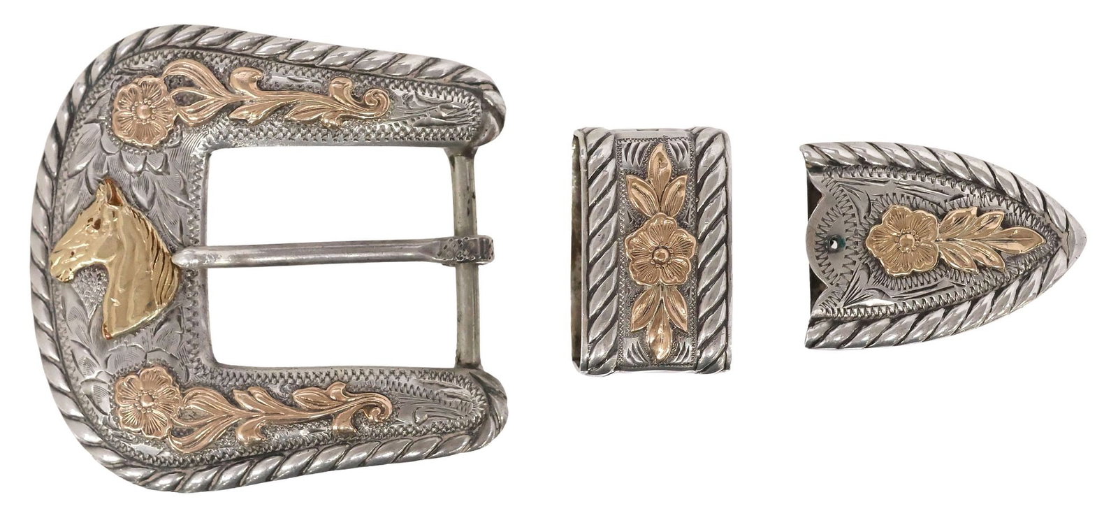 WESTERN STERLING SILVER & GOLD OVERLAY 3-PIECE RANGER BUCKLE SET: Western sterling silver and yellow gold overlay three-piece ranger buckle set, in the style of R. Schaezlein & Son, each with chased flowers and foliate motifs, twisted rope border, marked sterling, c