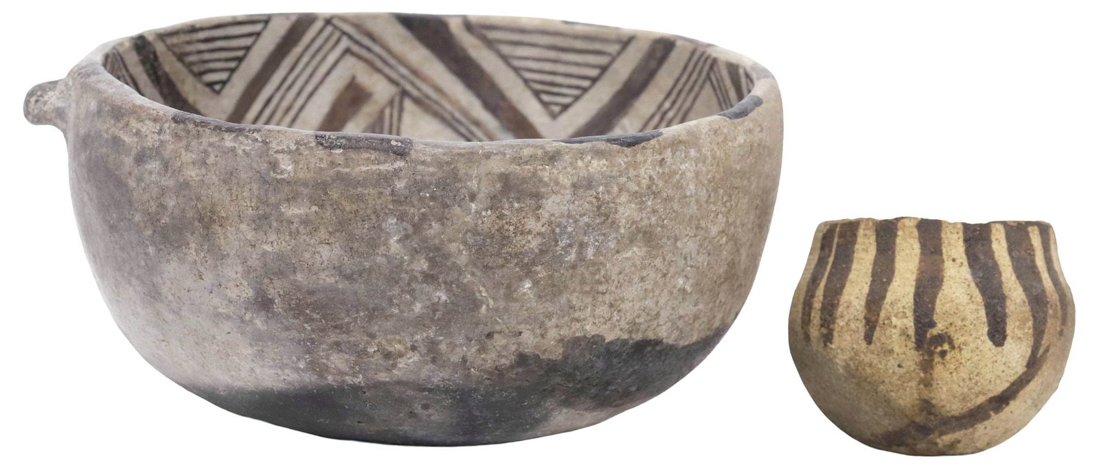 (2) NATIVE AMERICAN BLACK ON WHITE POTTERY BOWLS, POSSIBLY ANASAZI: (lot of 2) Native American black-on-white pottery bowls, possibly Anasazi, including: (1) tapering body with single pulled handle, geometric decoration to the interior, approx 2.75"h, 5 5/8"w, 5.25"d;