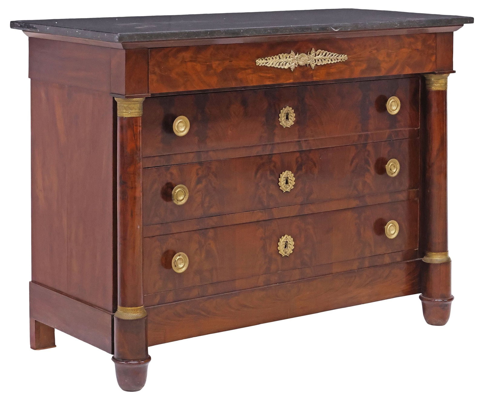 FRENCH EMPIRE STYLE MARBLE-TOP FLAME MAHOGANY COMMODE: French Empire style flame mahogany commode, 19th c., rectangular marble top, over protruding frieze drawer, and three standard drawers, flanked by columnar posts with gilt-metal capitals, on cup feet,