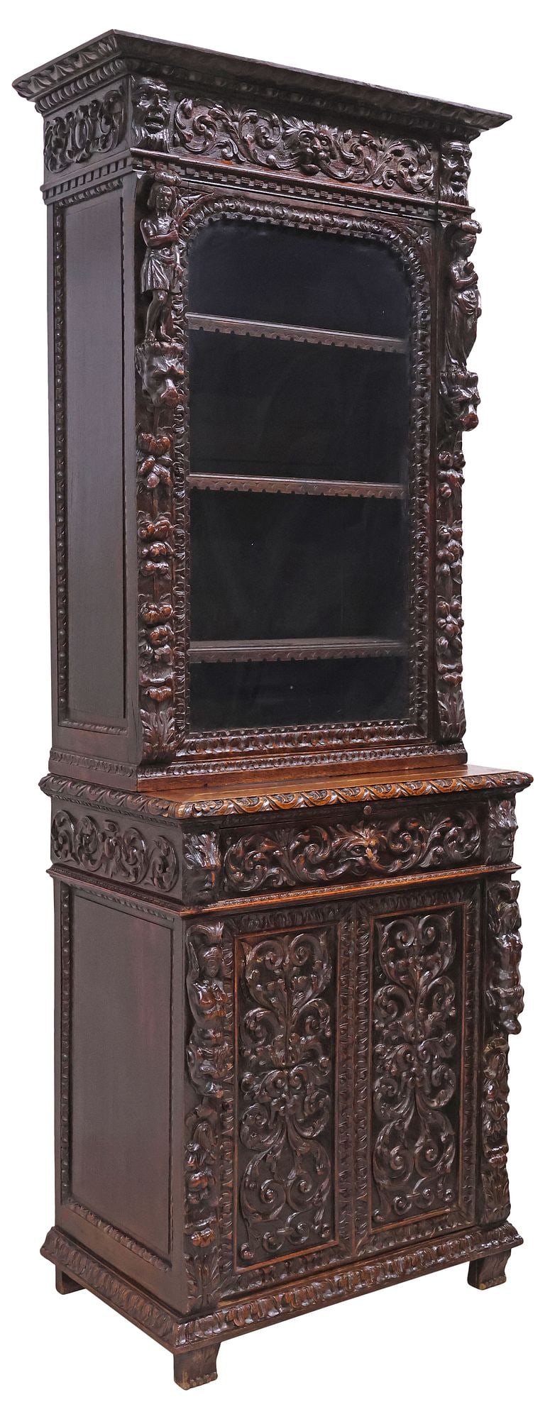 FRENCH RENAISSANCE REVIVAL CARVED OAK SECRETARY BOOKCASE: French Renaissance Revival carved oak secretary bookcase, late 19th c., molded cornice above a glazed cabinet door, opening to adjustable-height shelving, the lower case with writing slide and drawer,