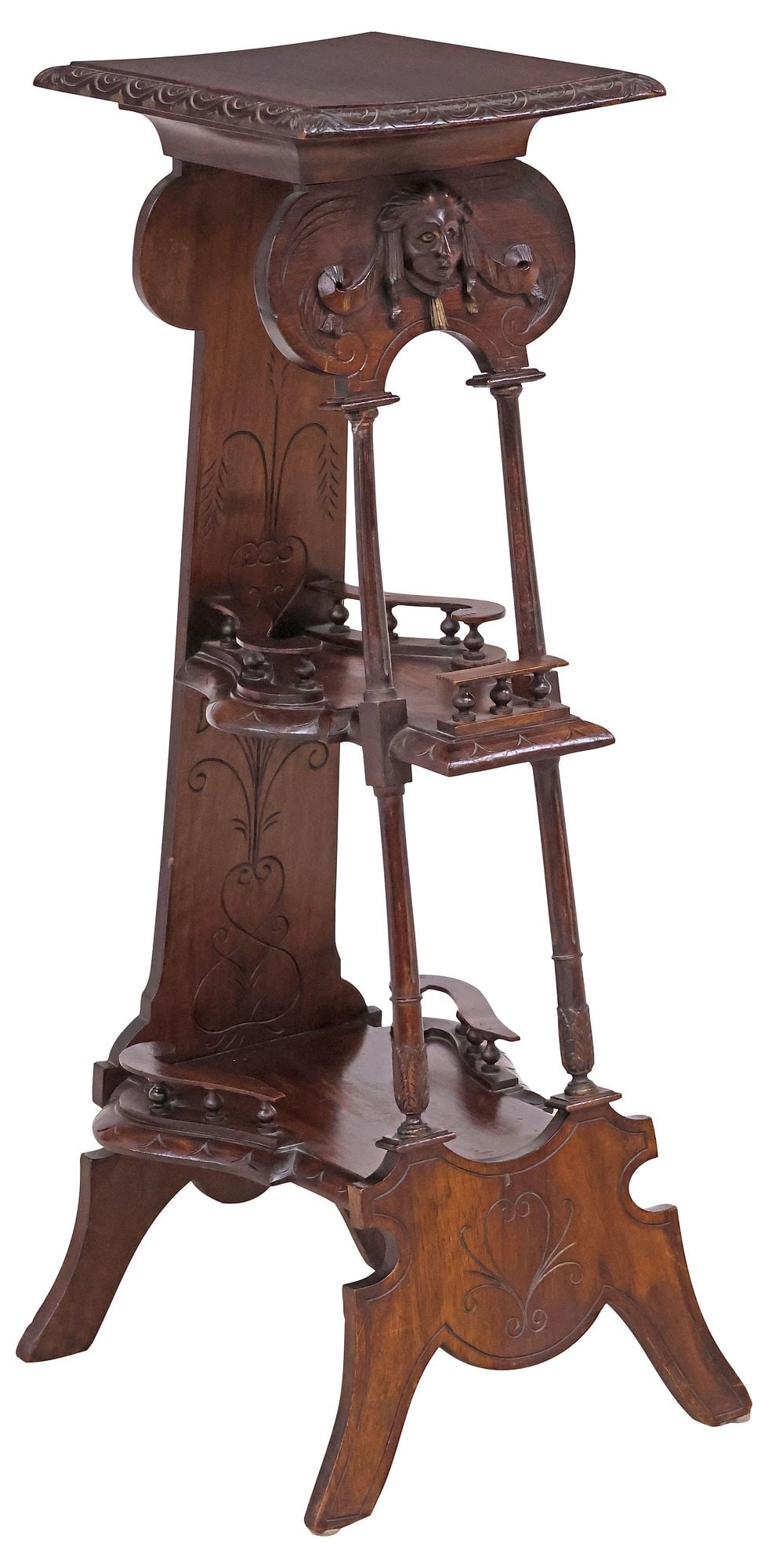 ITALIAN RENAISSANCE REVIVAL CARVED WALNUT PEDESTAL / STAND: Italian Renaissance Revival carved walnut pedestal/ plant stand, 19th c., having rectangular top with molded trim, over two shaped tiers, front with central mask motif, rising on fluted supports, endi