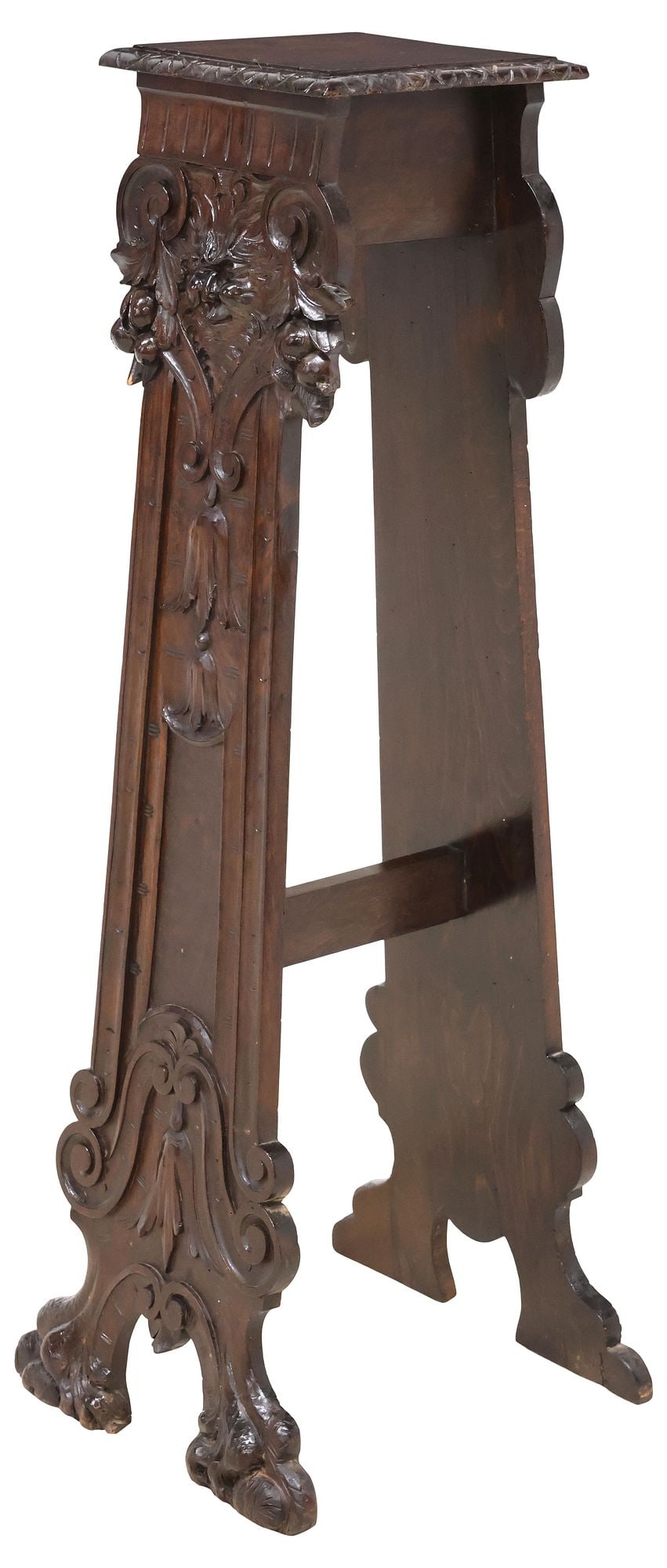 ITALIAN RENAISSANCE REVIVAL CARVED WALNUT PEDESTAL / STAND: Italian Renaissance Revival walnut pedestal/ plant stand, 19th c., squared top with carved edge, over shaped trestle supports joined by center stretcher, with foliate motifs and grotesque mask, rising