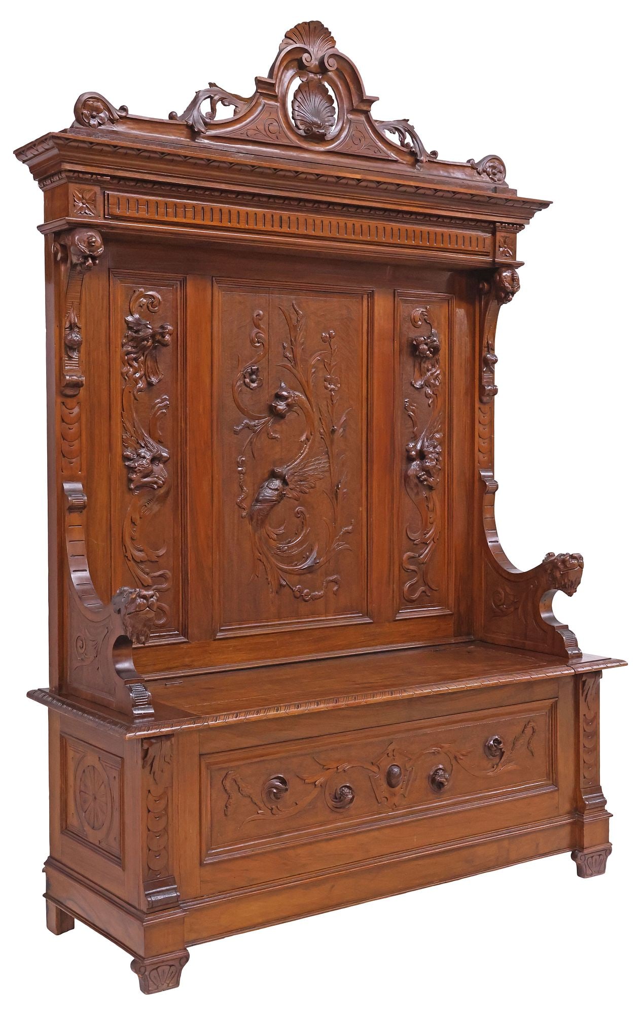 ITALIAN RENAISSANCE REVIVAL CARVED WALNUT HALL BENCH: Italian Renaissance Revival carved walnut hall bench, late 19th c., having scrolled crest with shell motif, paneled back with scrolled beasts in relief, dual grotesque mask handholds at either side of