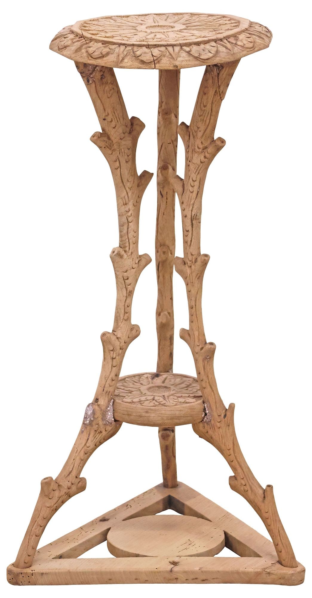 BLACK FOREST STYLE CARVED PEDESTAL / STAND ON FAUX BOIS SUPPORTS: Black Forest style carved oak tripartite pedestal/ display stand, having round top with floral and foliate motifs, rising on naturalistic faux bois tree branch-form supports, joined by medial shelf,
