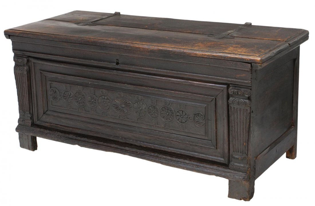 LARGE ITALIAN RENAISSANCE REVIVAL OAK TRUNK: Italian Renaissance Revival oak trunk or coffer, 18th/19th c., the top held by large strap hinges over the front with incised carved rosettes, the open interior with an old but later, raised on block 