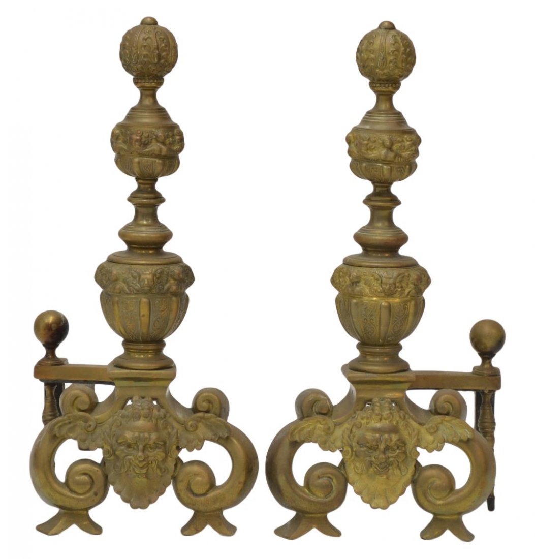 (PAIR) CONTINENTAL GILT BRASS FIGURAL CHENETS: (pair) Continental gilt brass fireplace andirons, the standard with figural and foliate decorated orbs, over a winged figural masque, on scrolled feet, numbered 569 verso, 27.25"h, 11.75"w, 23"d, appr