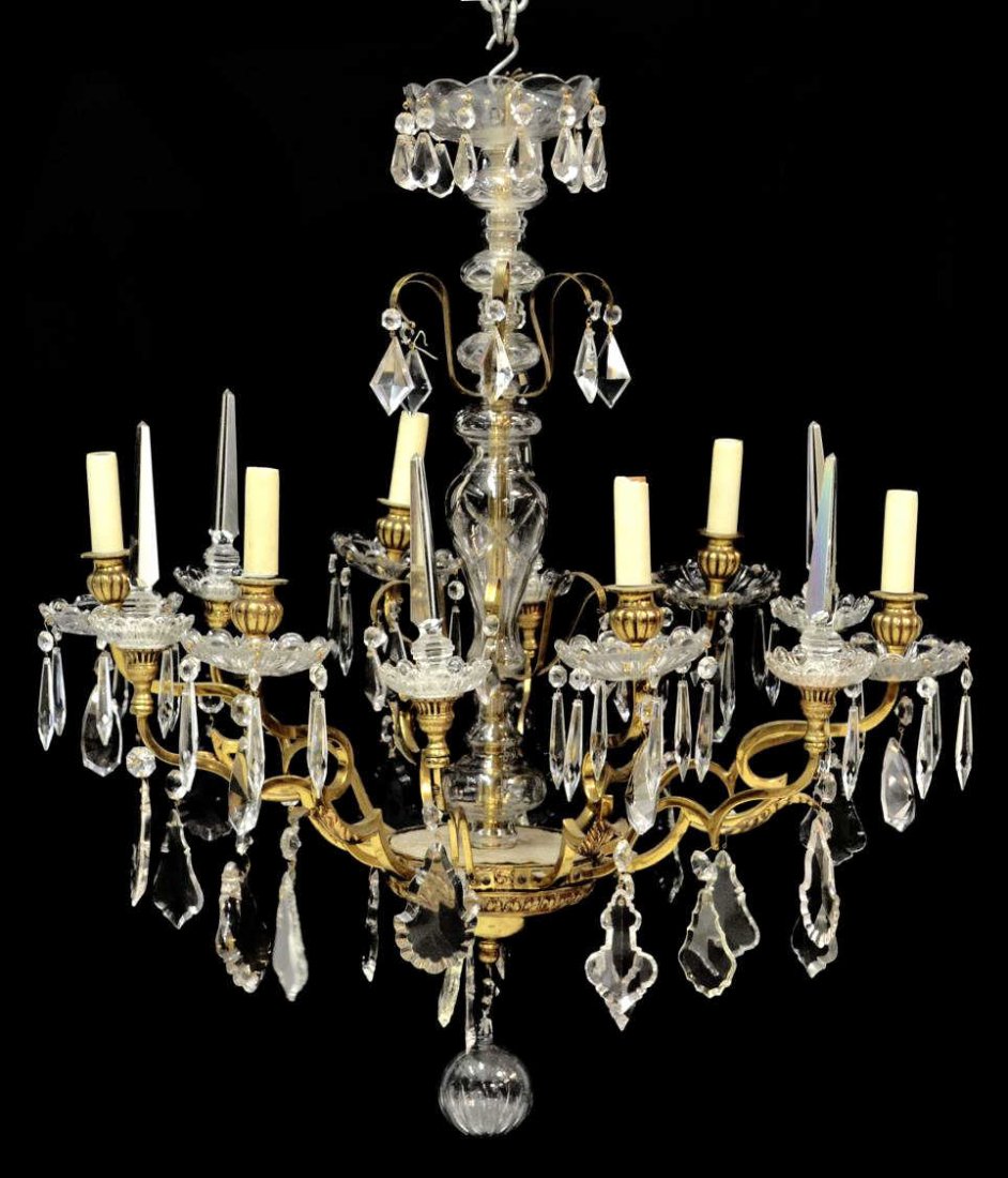 SPAIN CRYSTAL PRISM & GILT METAL CHANDELIER: Crystal and gilt metal six-light chandelier, Spain, clear glass standard surrounded by foliate arms terminating in glass bobeche and spear forms, the whole hung with faceted prisms, in need of wiring,
