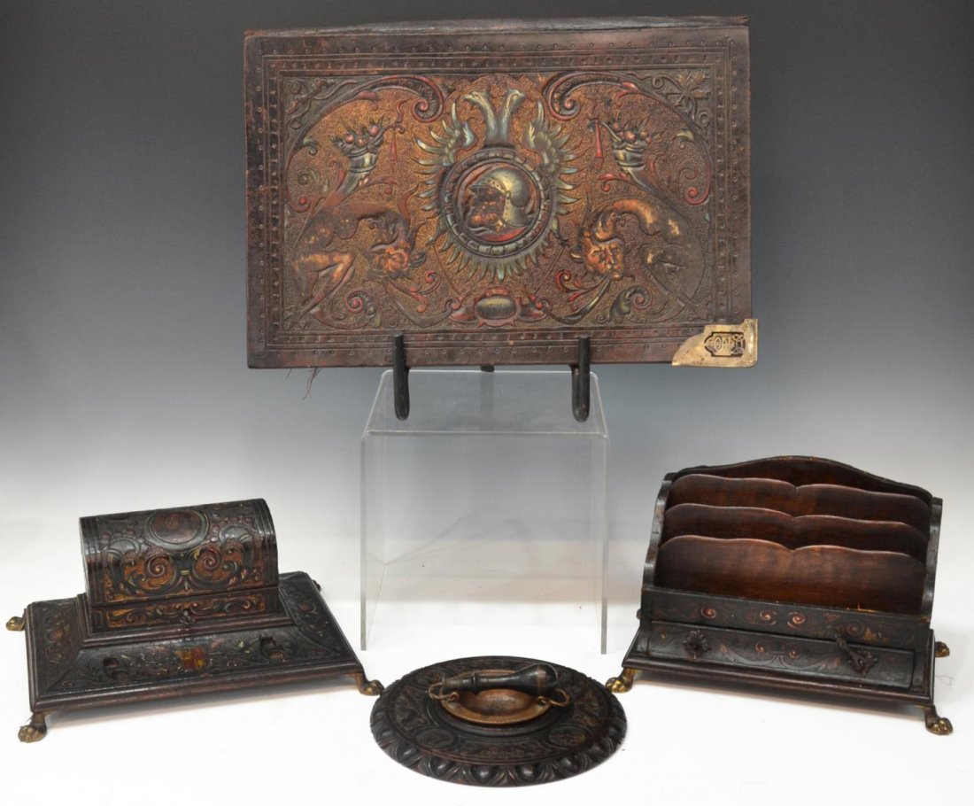 (4) RENAISSANCE STYLE EMBOSSED LEATHER DESK SET: (lot of 4) Renaissance Revival leather embossed desk set, polychrome figural scenes surrounded by coat of arms, scrolling foliage, and fruit decoration, comprising: (1) divided paper tray having a sin