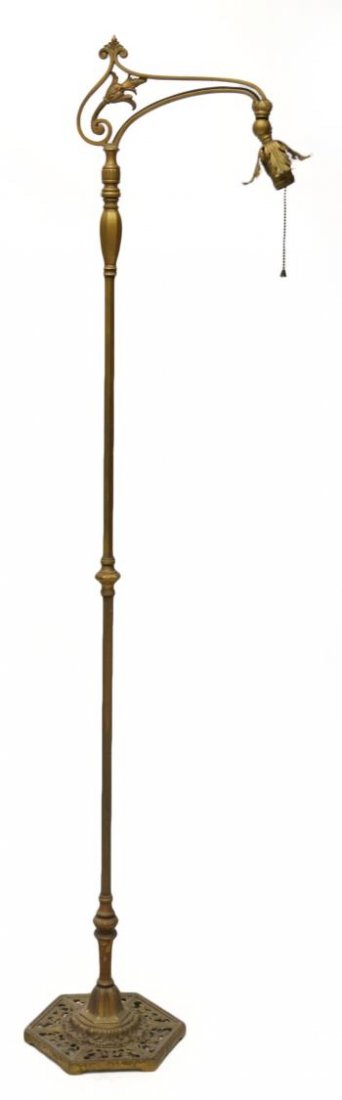 VINTAGE GILDED IRON STANDING BRIDGE LAMP: Vintage gilded iron floor lamp having a bridge with foliate motif, ribbed standard rising on a punctured scrolling hexagonal shaped base, retaining remnants of sticker underfoot, lacking shade, approx