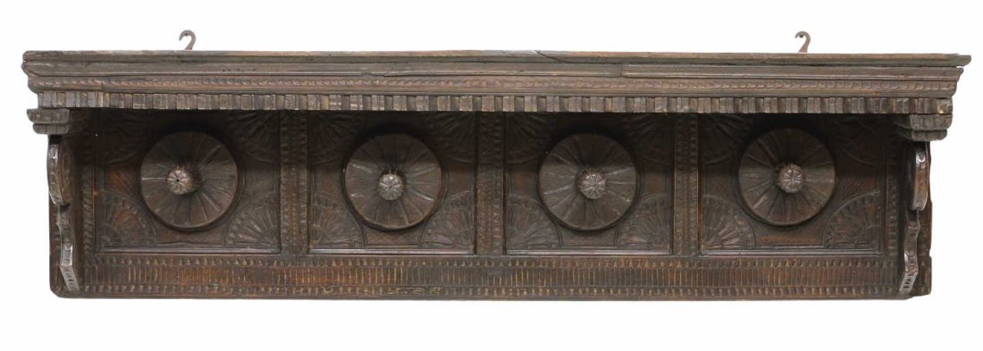 ANTIQUE WALL HANGING CARVED COAT RACK: Continental hanging coat rack, mid 19th c., having a stepped cornice over dentil molding, four protruding turned wood coat hooks, the back panel with substantial geometric carving, wood loss, 17.5"h, 