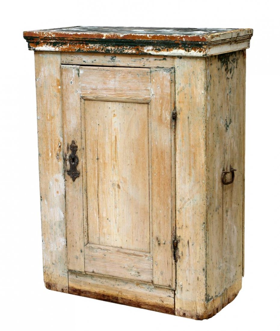 ANTIQUE EASTERN EUROPE PINE CUPBOARD: Primitive pine cupboard, likely Eastern Europe, 19th c., overall with worn and stripped polychrome paint remnants, a single door opening to the shelved interior, iron carry handles, 45.75"h, 34.75"w, 