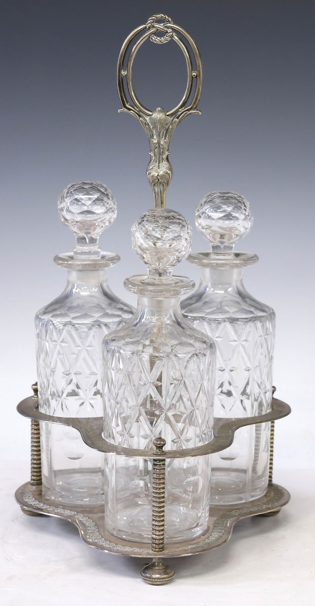 ENGLISH SILVERPLATE & CUT GLASS DECANTERS IN SILVERPLATE STAND (1 of 3)