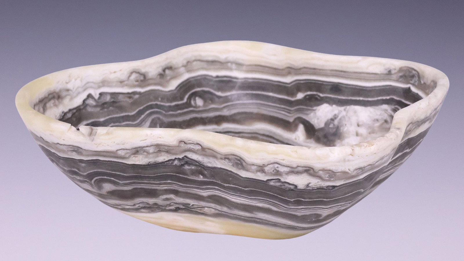 SMALL GEOLOGICAL NATURAL EDGE ONYX BOWL: Small geological honed-edge onyx bowl, of organic form, approx 3.5"h, 10"w, 8.25"d, 2.75lbs