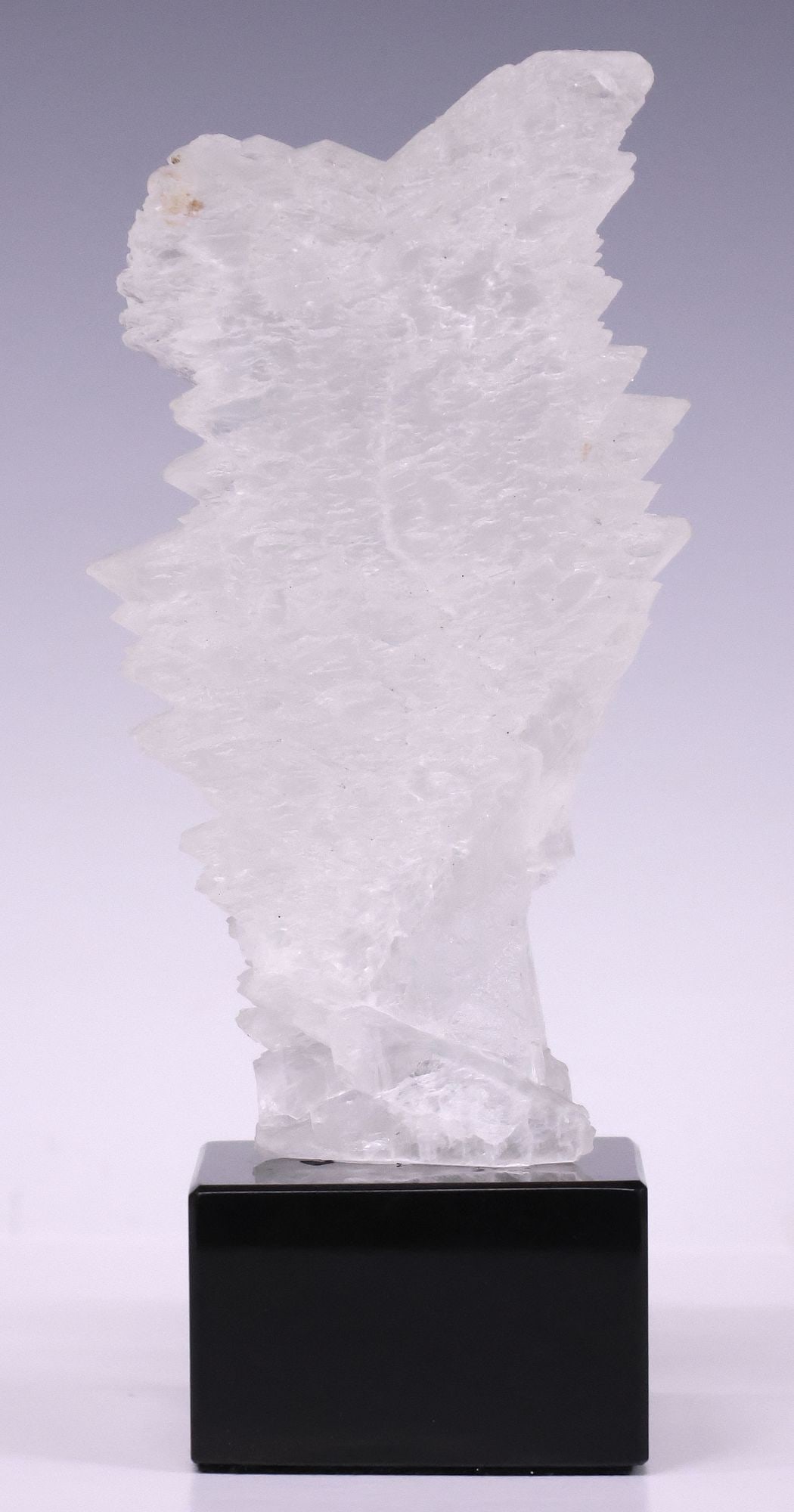 GEOLOGICAL FISHTAIL SELENITE SPECIMEN ON BLACK MARBLE BASE: Geological fishtail selenite specimen, on black marble base, specimen: approx 6.25"h, 3.75"w, 2"d, overall: approx 8"h, 2.5"w, 2.5"d, 2.25lbs