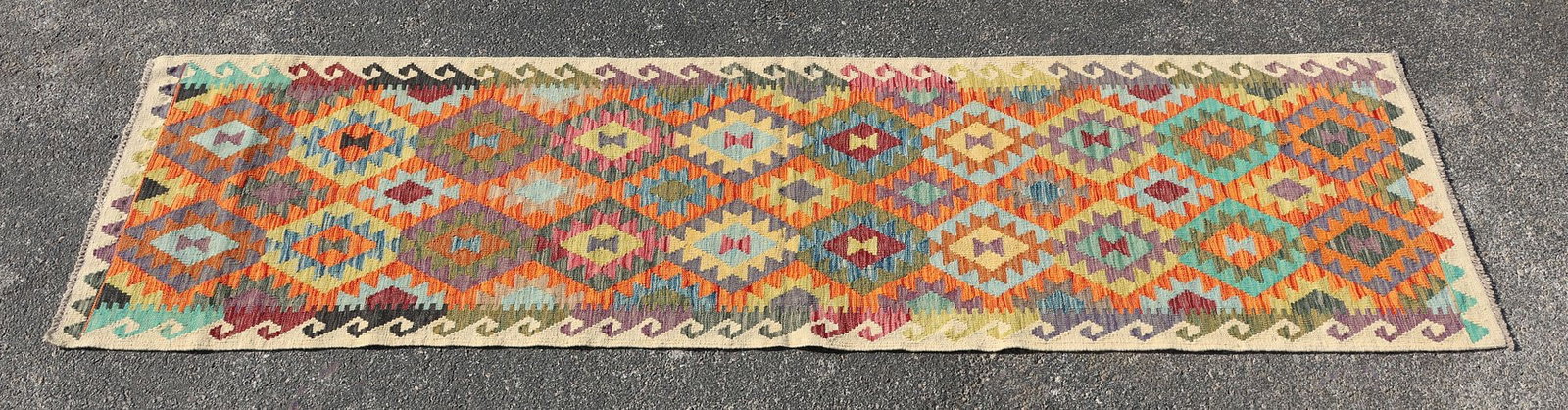ESTATE FLATWOVEN KILIM RUNNER, 9'10" X 2'7.5": Estate flatwoven Kilim rug, approx 9'10"l, 2'7.5"w **Please Note: All of the rugs offered in this auction would likely benefit from a professional cleaning. Estate rugs may show some wear and imperfec