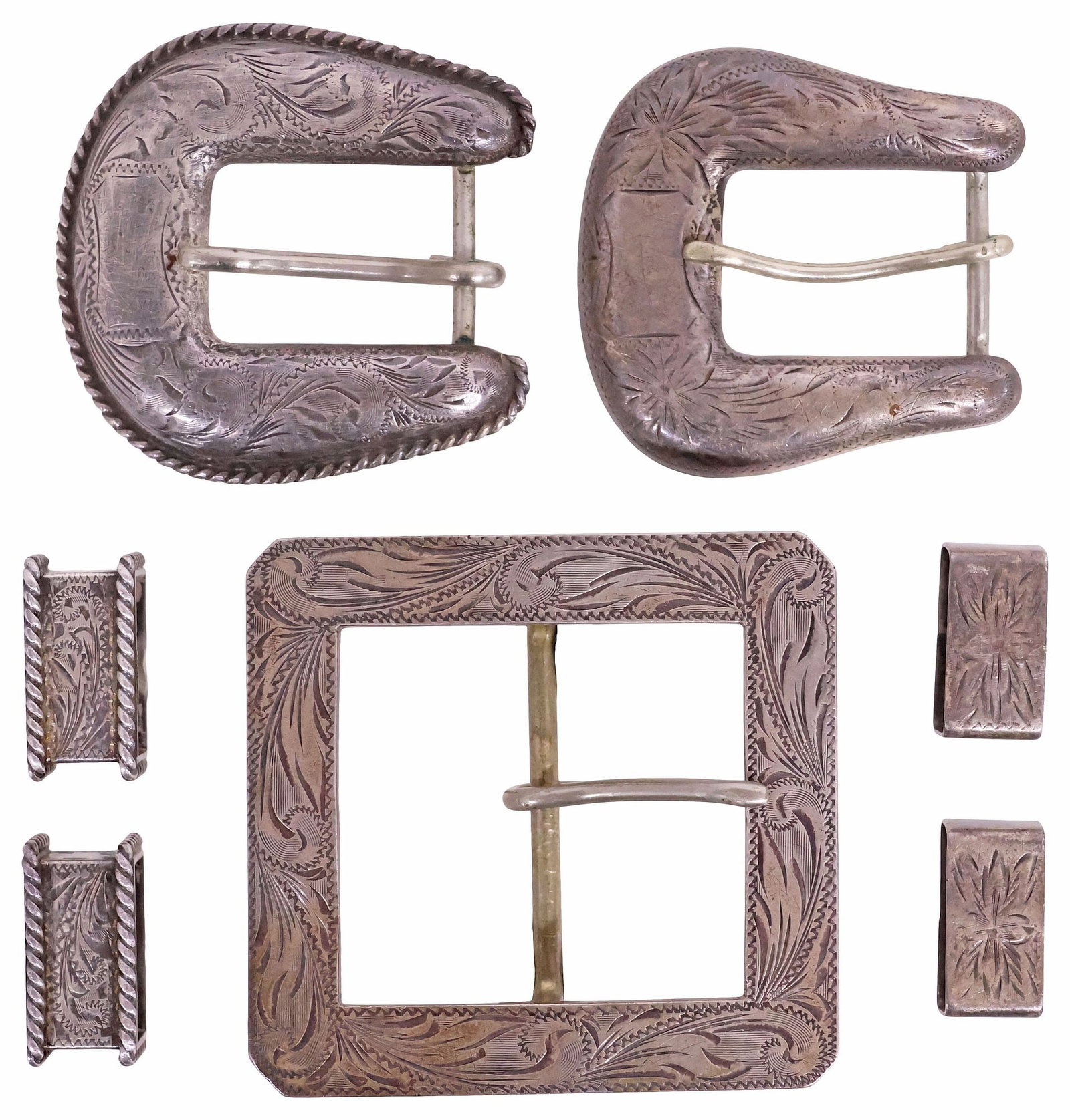 (7) VINTAGE SUNSET TRAILS STERLING SILVER BELT BUCKLES & KEEPERS: (lot of 7) Western sterling silver belt buckles, Sunset Trails, Los Angeles, each with maker's marks and hallmarks, varied designs, including: (1) canted square buckle with scrolling foliates, approx 