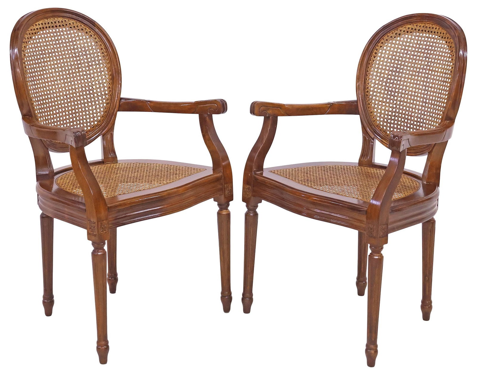 (2) FRENCH LOUIS XVI STYLE CANED WALNUT ARMCHAIRS: (pair) French Louis XVI style caned armchairs, late 20th c., caned oval back and seat, arms with scrolled handholds, rising on fluted tapering legs headed by carved floral motifs, ending on arrow feet