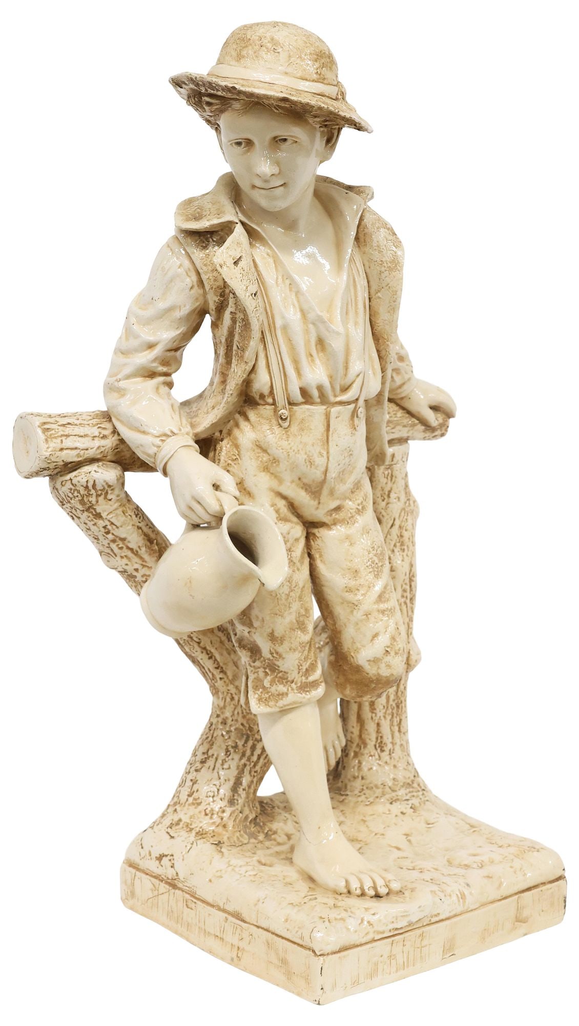 LARGE ENGLISH BRETBY ART POTTERY FIGURE, RUSTIC YOUNG BOY, 29.5"H: Large English creamware figure, Bretby Art Pottery, late 19th/ early 20th c., modeled as a young boy in rural dress, leading on a wood fence post with pitcher in one hand, on integral naturalistic bas