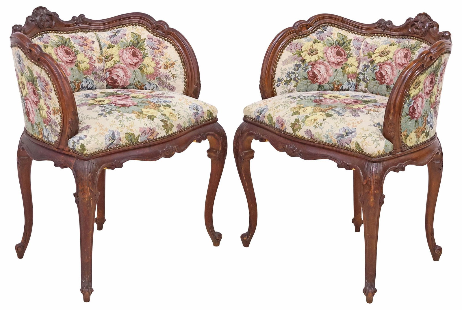 (2) FRENCH LOUIS XV STYLE CARVED & UPHOLSTERED WALNUT ARMCHAIRS: (pair) French Louis XV style carved walnut bergeres/ armchairs, late 19th c., each with shell crest and scrolled top rail, padded back and seat in a later floral jacquard upholstery, with nail-head