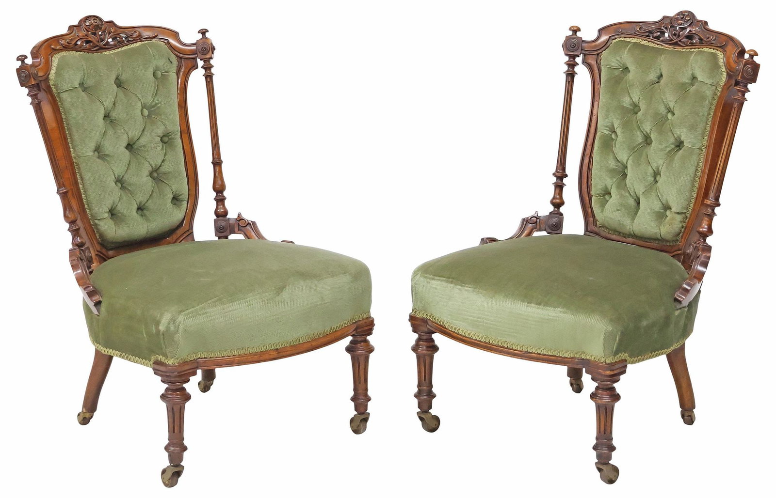 (2) ENGLISH VICTORIAN UPHOLSTERED WALNUT PARLOR / SLIPPER CHAIRS: (pair) English Victorian carved walnut parlor or slipper chairs, late 19th c., each having button-tufted back and padded seat in green velvet upholstery, with floral crest, flanked by fluted columnar