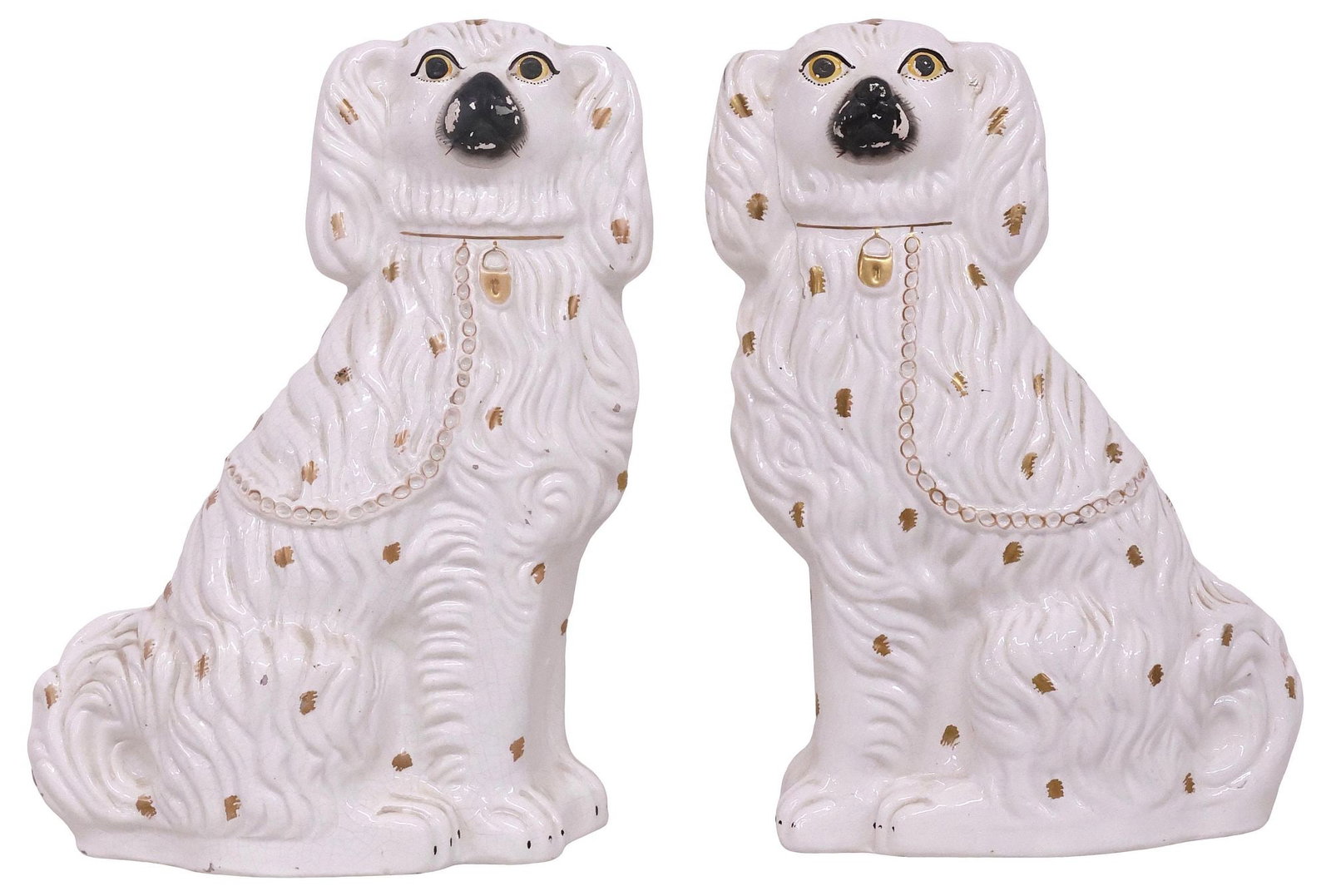 (2) LARGE ENGLISH VICTORIAN STAFFORDSHIRE MANTEL DOGS: (pair) Large English Victorian Staffordshire mantel dogs, late 19th c., each modeled as a seated spaniel, with painted features, and remnants of parcel-gilt decoration, (one) intact with stable hairli