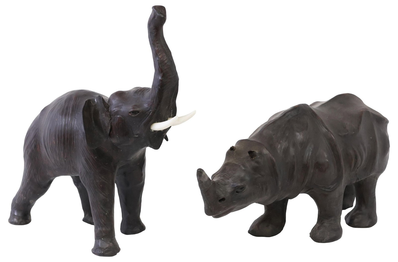 (2) LEATHER-CLAD ANIMAL SCULPTURES, ELEPHANT & RHINOCEROS: (lot of 2) Leather-clad animal sculptures, each with inset glass eyes, standing with upward-facing gaze, including: (1) elephant, with inset tusks, approx 12.5"h, 11"w, 4.75"d; (1) rhinoceros, loss