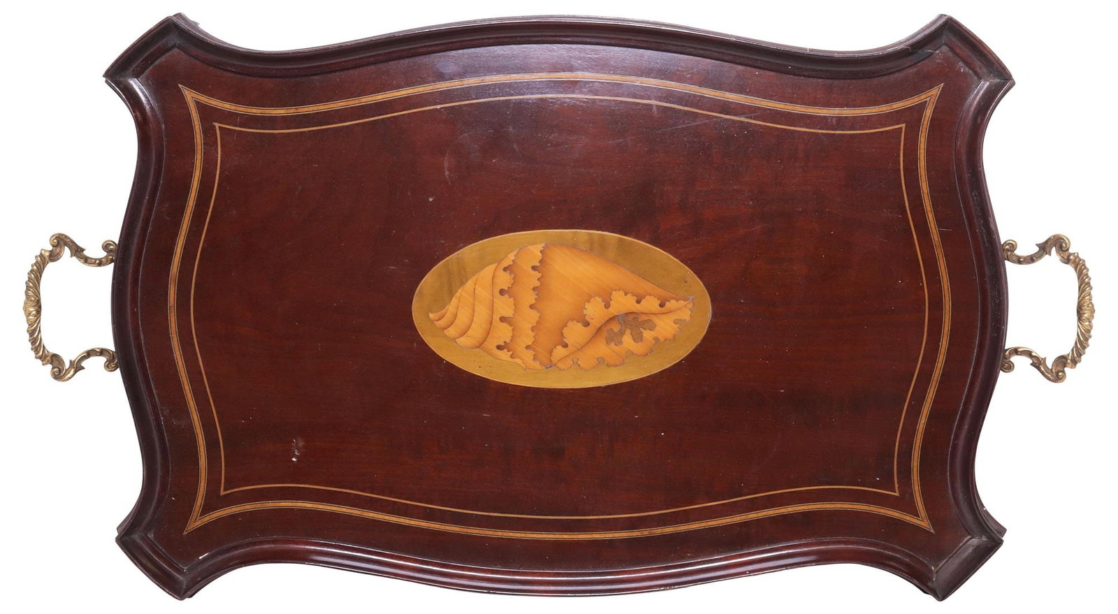 ENGLISH EDWARDIAN NAUTILUS SHELL INLAID MAHOGANY SERVICE TRAY: English Edwardian mahogany service tray, early 20th c., having shaped edge, stringwork trim, central marquetry shell motif, flanked by scrolled handles, glued repair to veneer at one corner, approx