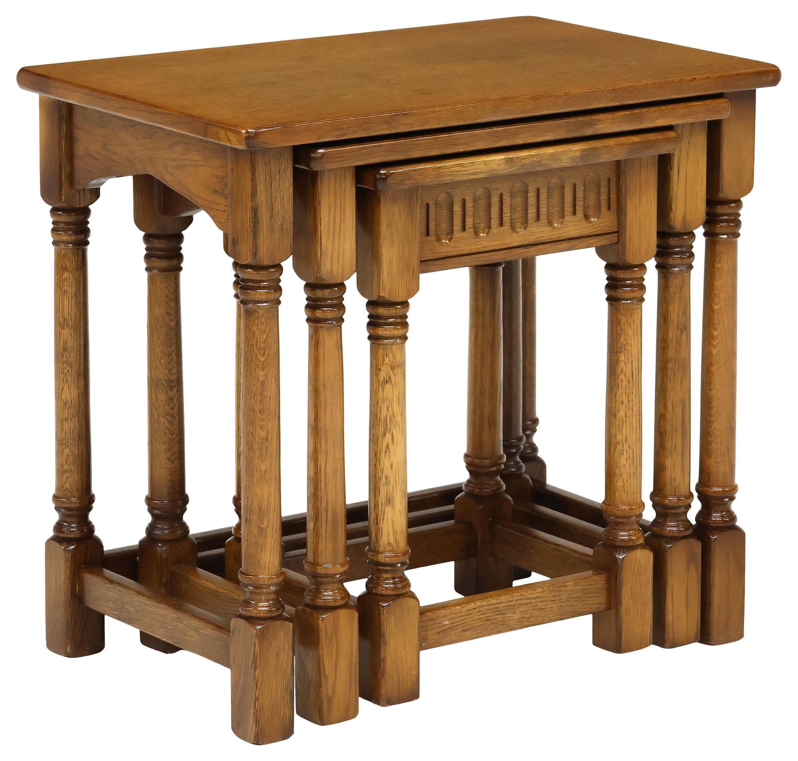 (3) ENGLISH CARVED OAK NESTING TABLES: (lot of 3) English oak nesting tables, 20th c., each with rectangular top and fluted apron, raised on columnar supports, ending on stretcher-joined block feet, largest: approx 21.25"h, 23"w, 15"d, sma