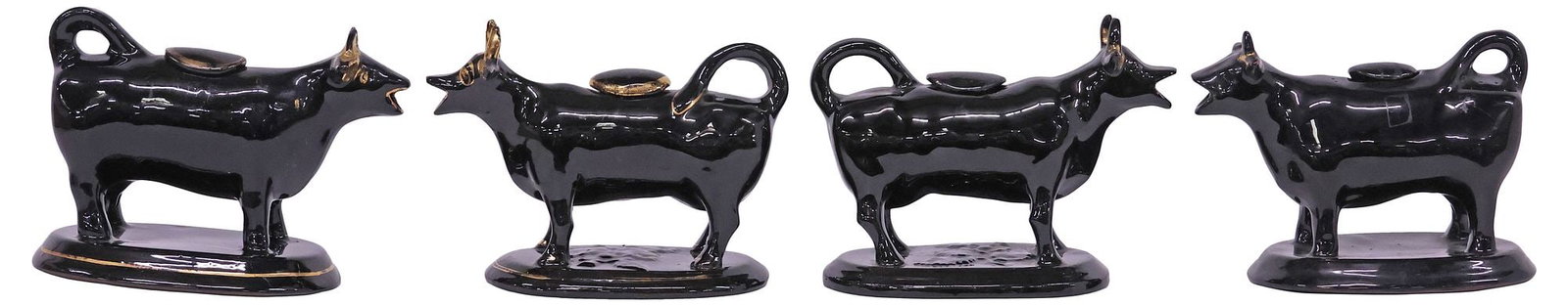 (4) ENGLISH STAFFORDSHIRE JACKFIELD GLAZE COW CREAMERS: (lot of 4) English Staffordshire cow creamers, 20th c., each in a Jackfield black glaze, with parcel-gilt features, rising on ovular base, largest: approx 5.5"h, 7.25"w, 3.75"d, 4.5lbs total