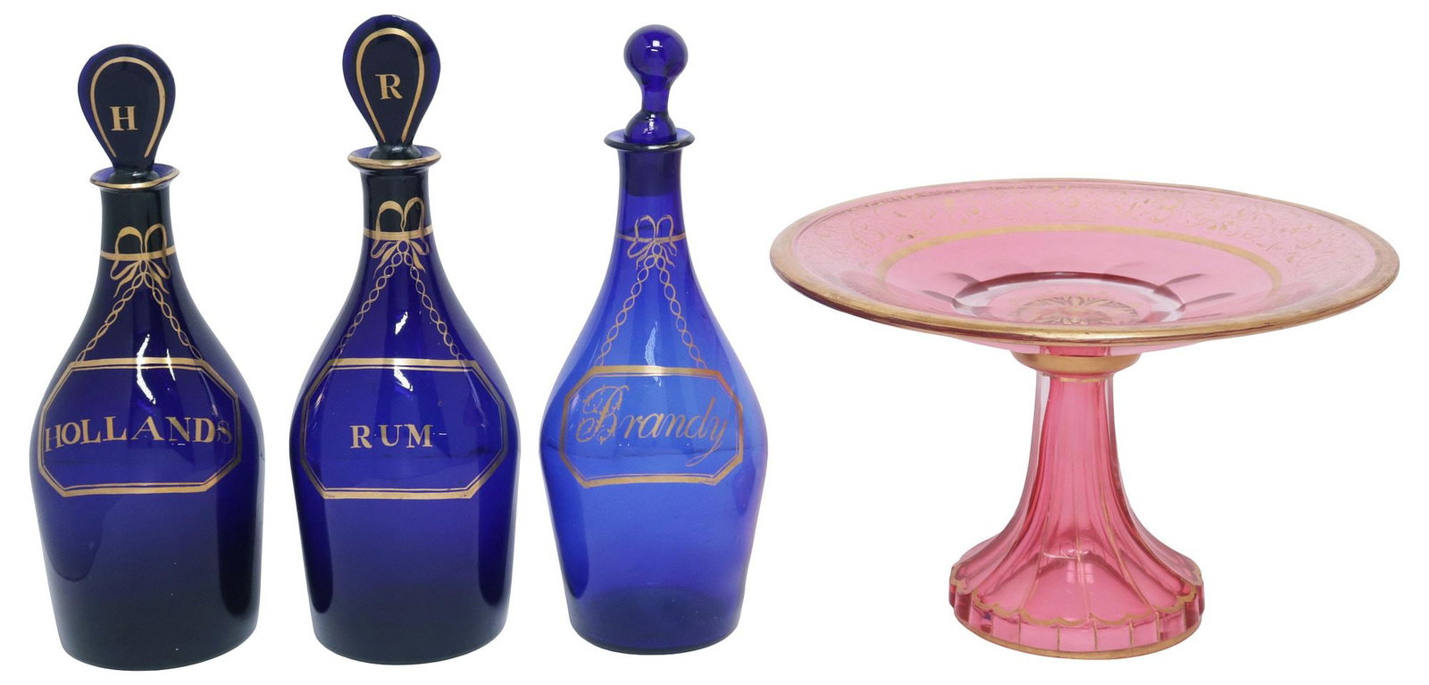 (4) ENGLISH PARCEL-GILT BRISTOL BLUE DECANTERS & MOSER STYLE CRANBERRY TAZZA: (lot of 4) Parcel-gilt table items, 19th/ 20th c., including: (3) Bristol blue decanters, likely English Regency period, each with chain and label design, comprising of: (one) "Hollands," (one) "Rum,"