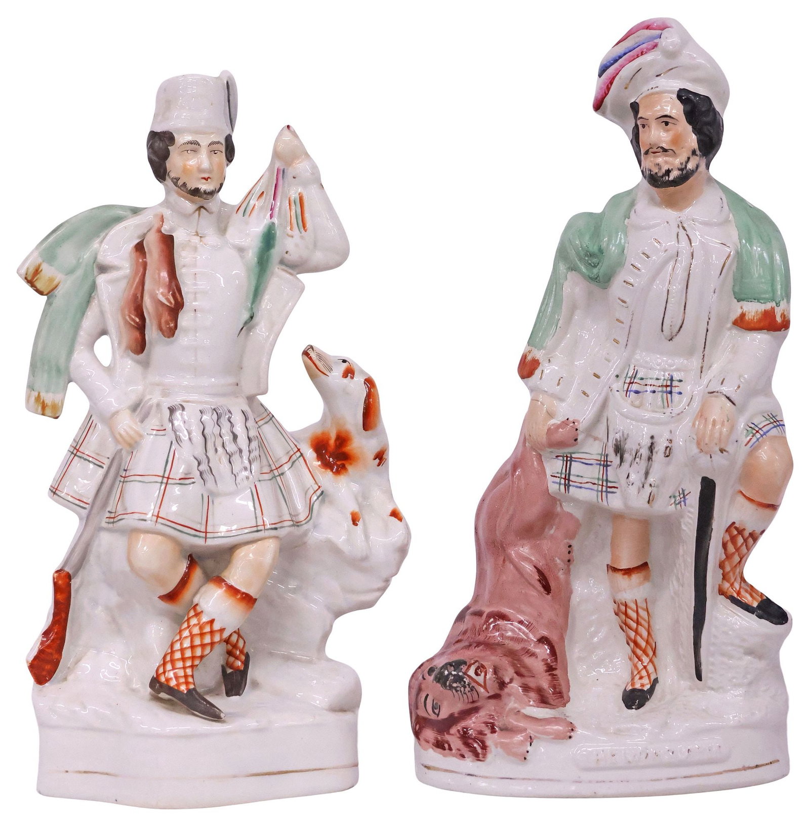 (2) ENGLISH VICTORIAN STAFFORDSHIRE SCOTTISH HUNTER MANTEL FIGURES: (lot of 2) English Victorian Staffordshire mantel figures, 19th c., each modeled as a Scottish hunter with elaborate headwear and plaid kilt, including: (1) "Lion Slayer," with title plaque, stable ha