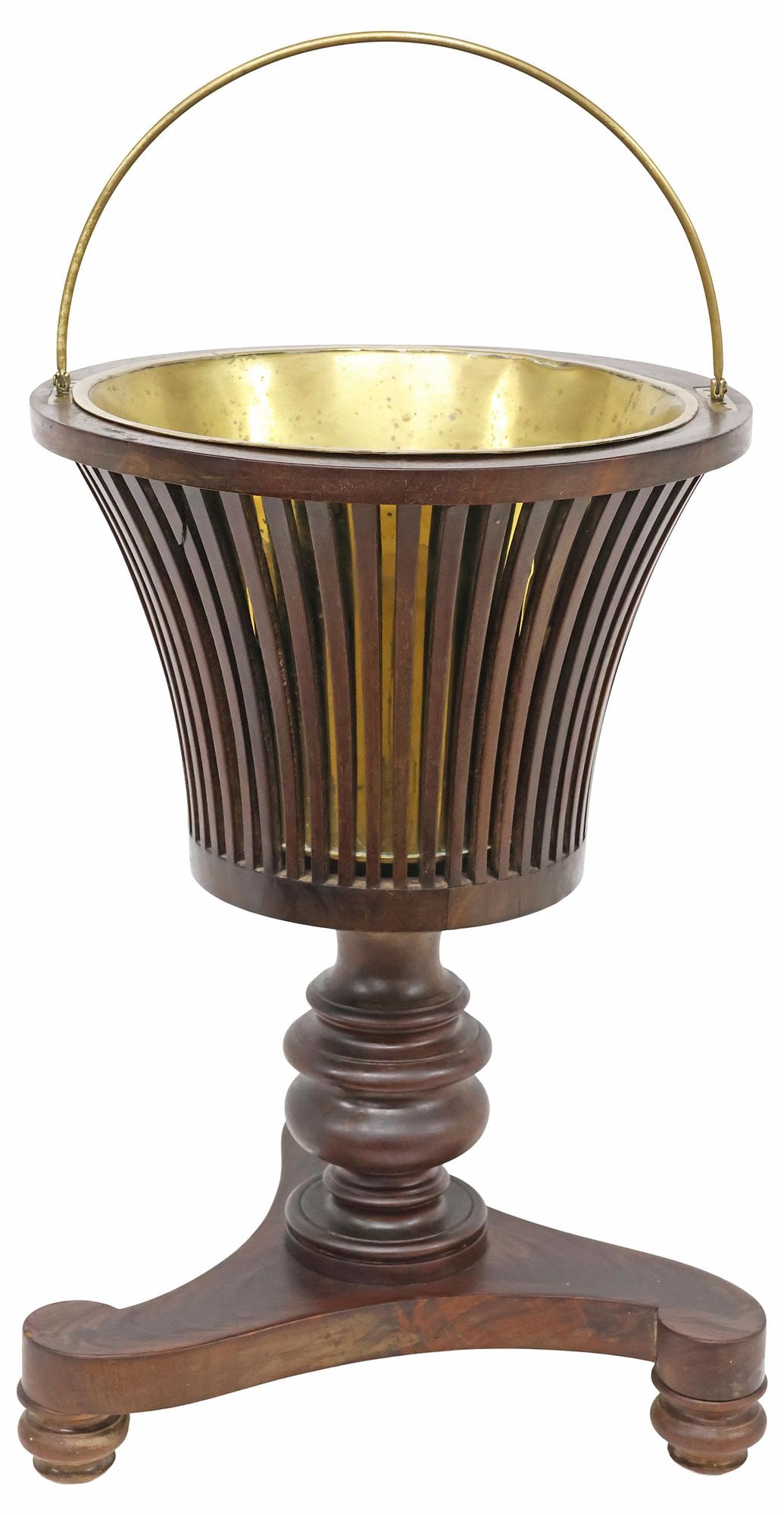 DUTCH SLATTED MAHOGANY URN-FORM 'TEESTOOF' TEA KETTLE BUCKET: Mahogany "teestoof" bucket or tea kettle brazier, Holland, 19th c., having slatted vasiform body, with metal bail handle and removable brass liner, rising on turned pedestal and tripartite base, furth