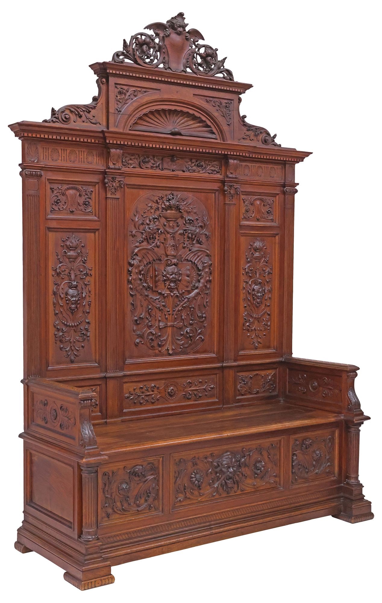 ITALIAN RENAISSANCE REVIVAL CARVED WALNUT HALL BENCH: Italian Renaissance Revival carved walnut hall bench, early 20th c., having fanned shell crest, over breakfront cornice and paneled back, with grotesque masks, flowering urns, and foliate scrollwork, 