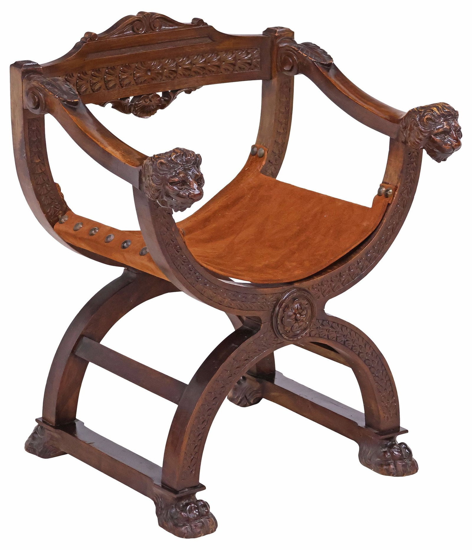 ITALIAN RENAISSANCE REVIVAL CARVED WALNUT SAVANAROLA CHAIR: Italian Renaissance Revival walnut savonarola chair, early 20th c., suede sling seat, flanked by carved arms ending in lion mask handholds, curule-form frame with floral rotund and foliate motifs, joi