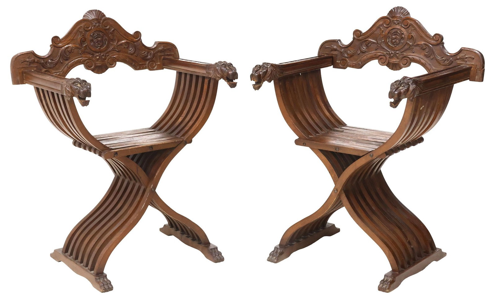 (2) ITALIAN RENAISSANCE REVIVAL WALNUT SAVONAROLA CURULE CHAIRS: (pair) Italian Renaissance Revival Savonarola chairs, early 20th c., scrolled seatback with fanned shell crest, over folding slatted frame, lion mask hand holds, rising on shoe base with paw feet, (on