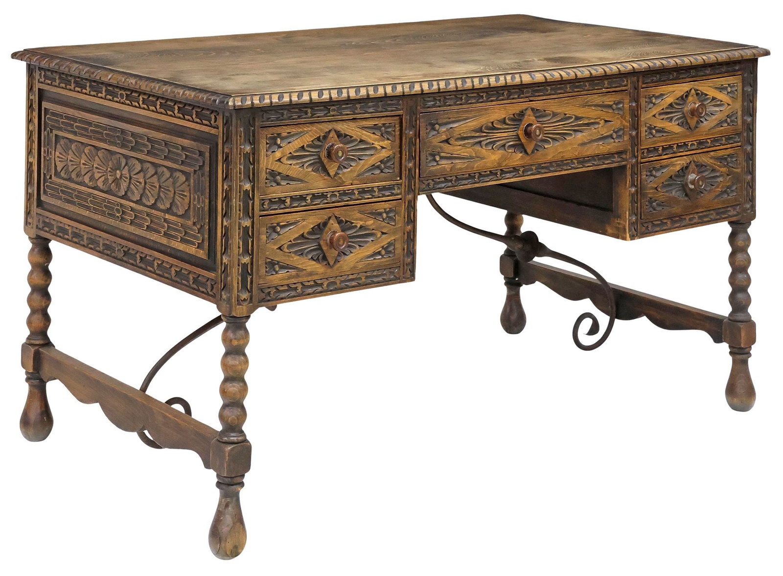 SPANISH BAROQUE STYLE CARVED OAK PEDESTAL WRITING DESK: Spanish Baroque style oak pedestal writing desk, 20th c., finished on all sides, having rectangular top with gadrooned trim, over five paneled drawers with carved floral and foliate motifs, rising on 