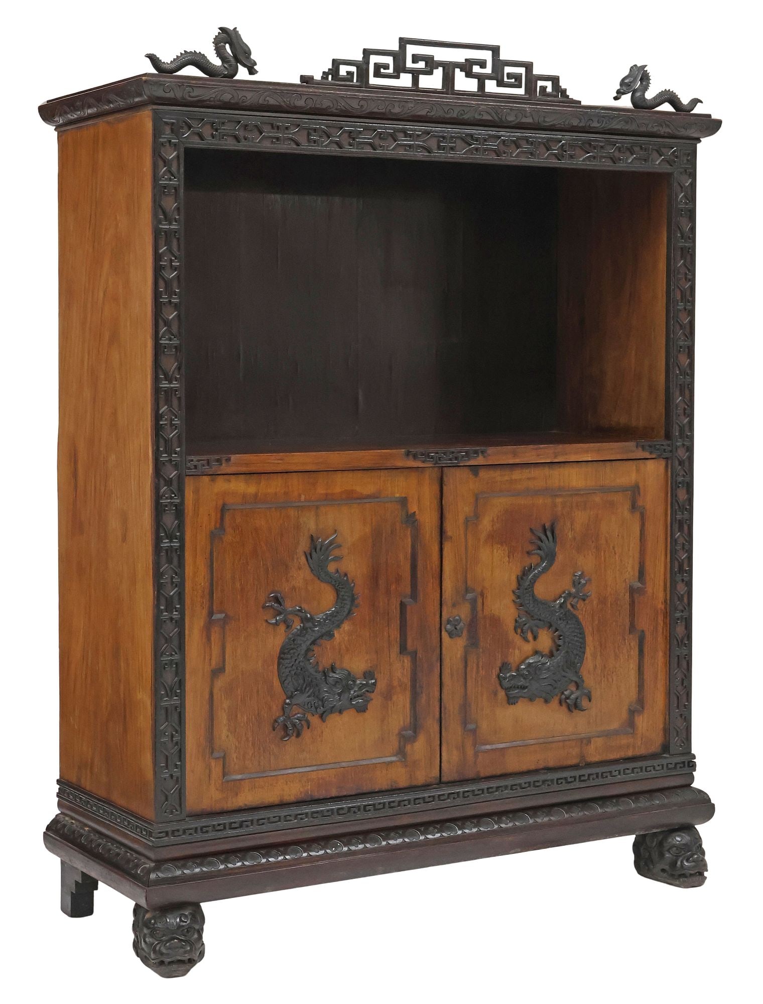 CHINESE CARVED WOOD 2-DOOR DRAGON CABINET: Chinese wood cabinet, having carved crest with fretwork and dragons, blind fretwork trim and open niche, over double-door cabinet, opening to interior shelf, rising on feet modeled as foo lion masks, 