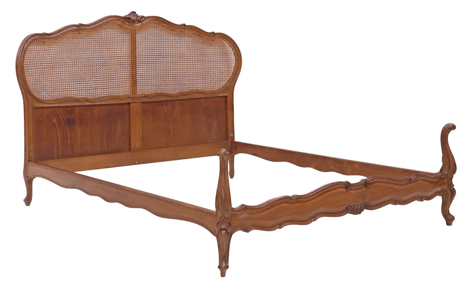 FRENCH LOUIS XV STYLE CANED WALNUT BED: French Louis XV style walnut bed, early 20th c., fanned foliate crest, over caned headboard, footboard with raised scrolling corner posts, rising on cabriole legs and whorl feet, exterior: approx