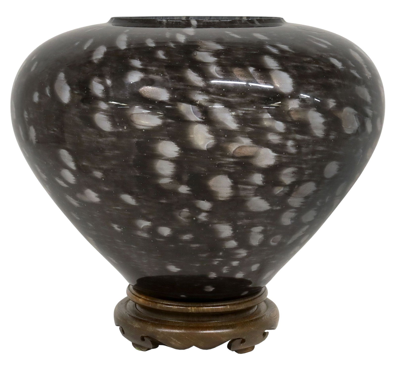 LARGE ITALIAN MURANO ART GLASS CENTERPIECE VASE ON WOOD STAND: Large Italian Murano art glass centerpiece vase, 20th c., having tapering body, in a mottled black and grey finish with gold fleck inclusions, retaining adhesive maker's label, rising on unassociated 