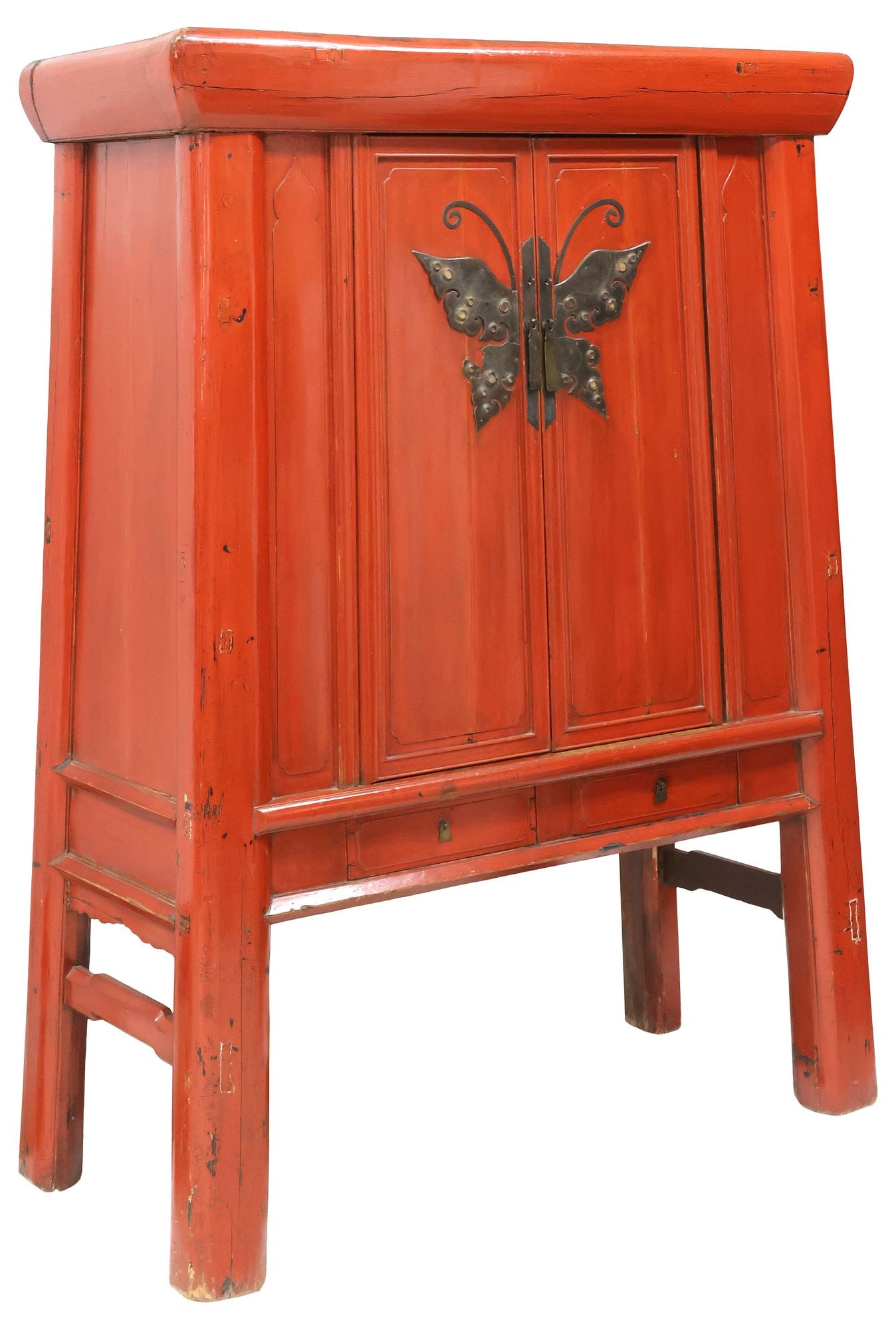 LARGE CHINESE RED LACQUER WEDDING CABINET WITH BUTTERFLY MOUNT: Antique Chinese red lacquer wedding cabinet, of pyramidical form, pair of paneled doors with patinated metal butterfly mount, enclosing fixed-height shelving and two small drawers, above two additiona
